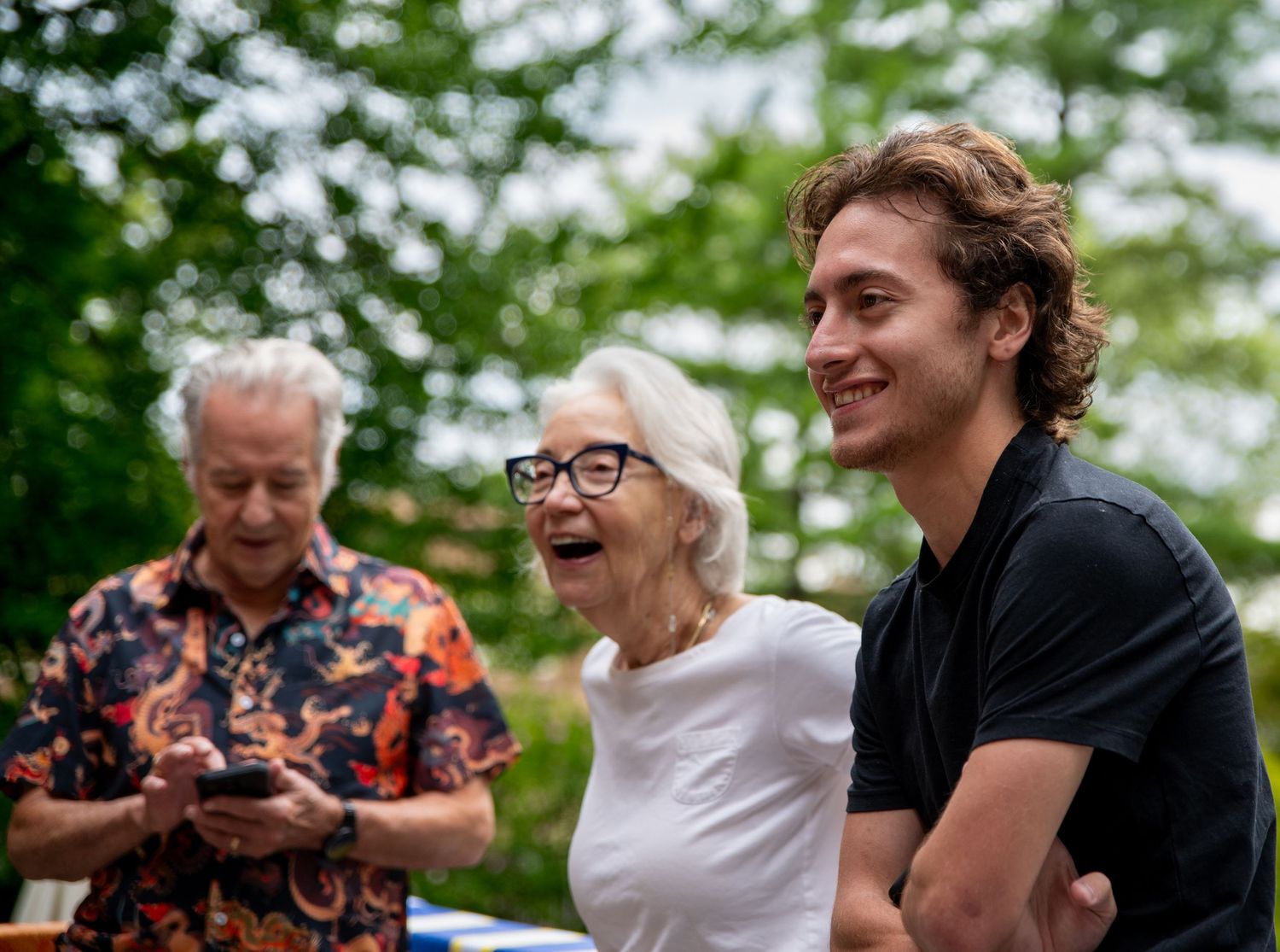 people laughing outdoors. Photo by Elijah Grace Photo.