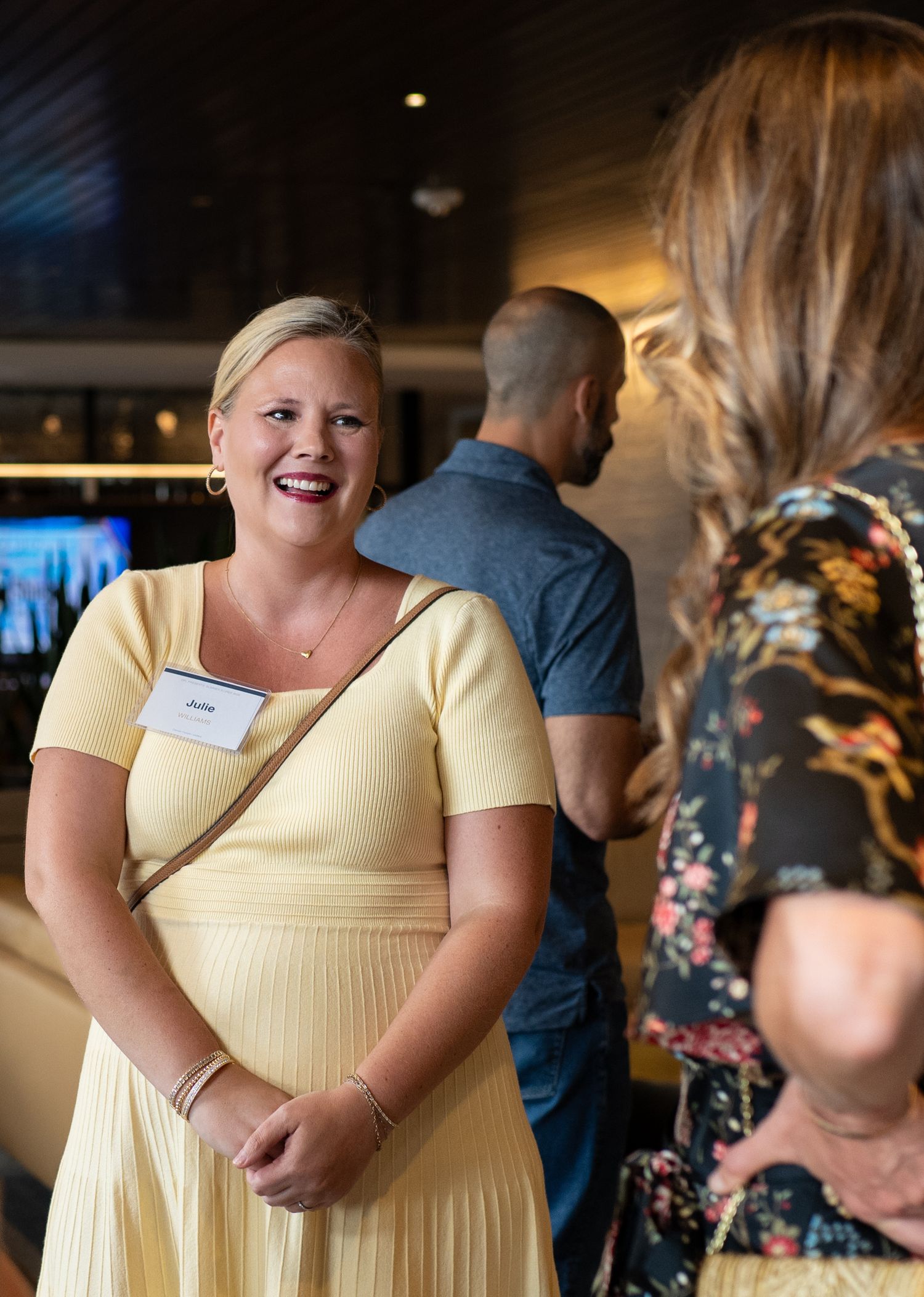 Professionals talking at Denver People Leaders Summer Soiree at Janus Henderson in Denver, CO