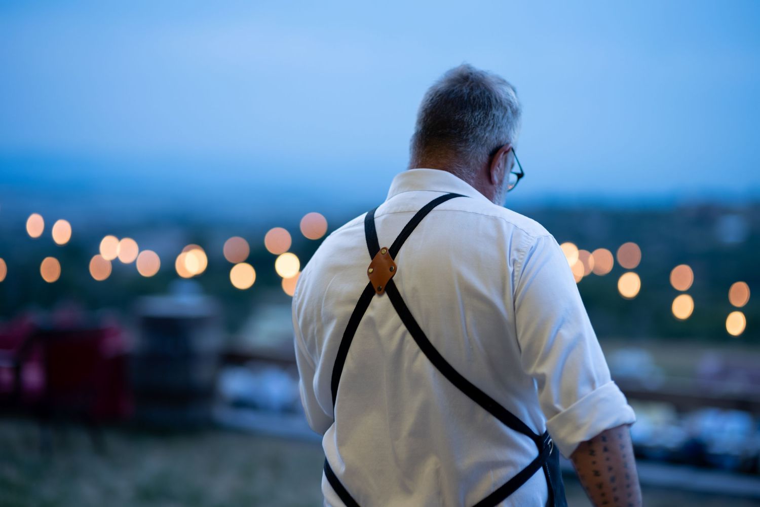 Man walking away with blue bokeh background