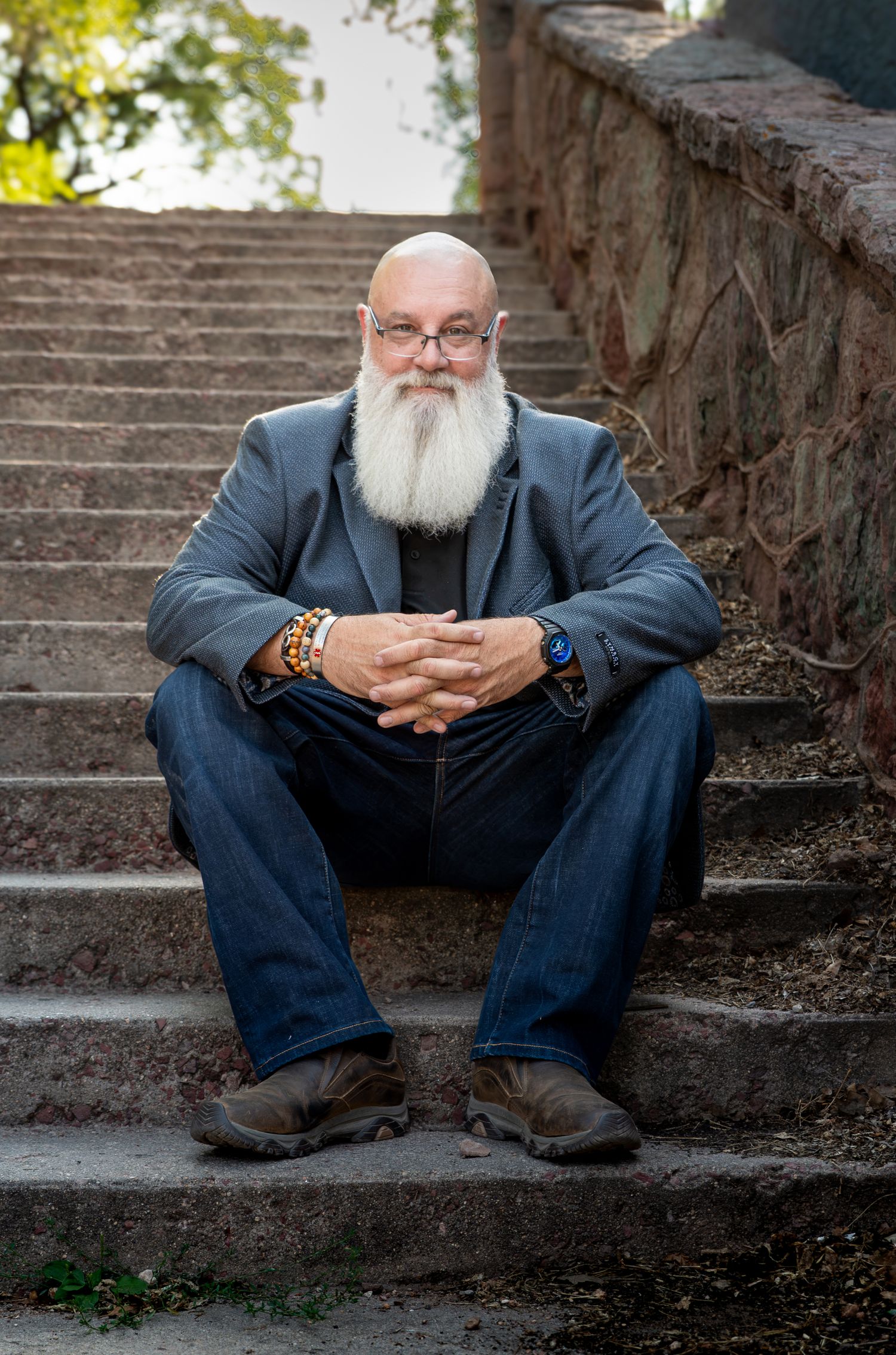 Man sitting on steps in Manitou Springs, CO. Photo by Elijah Grace Photo.