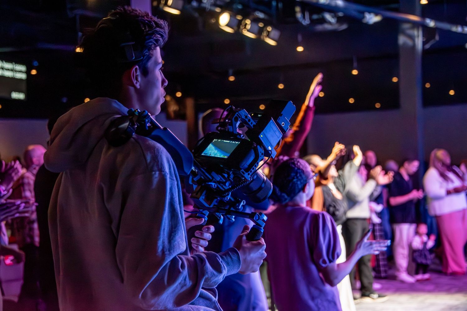 people with hands raised for worship at Zeal Church, Colorado Springs. Photo by Elijah Grace Photo