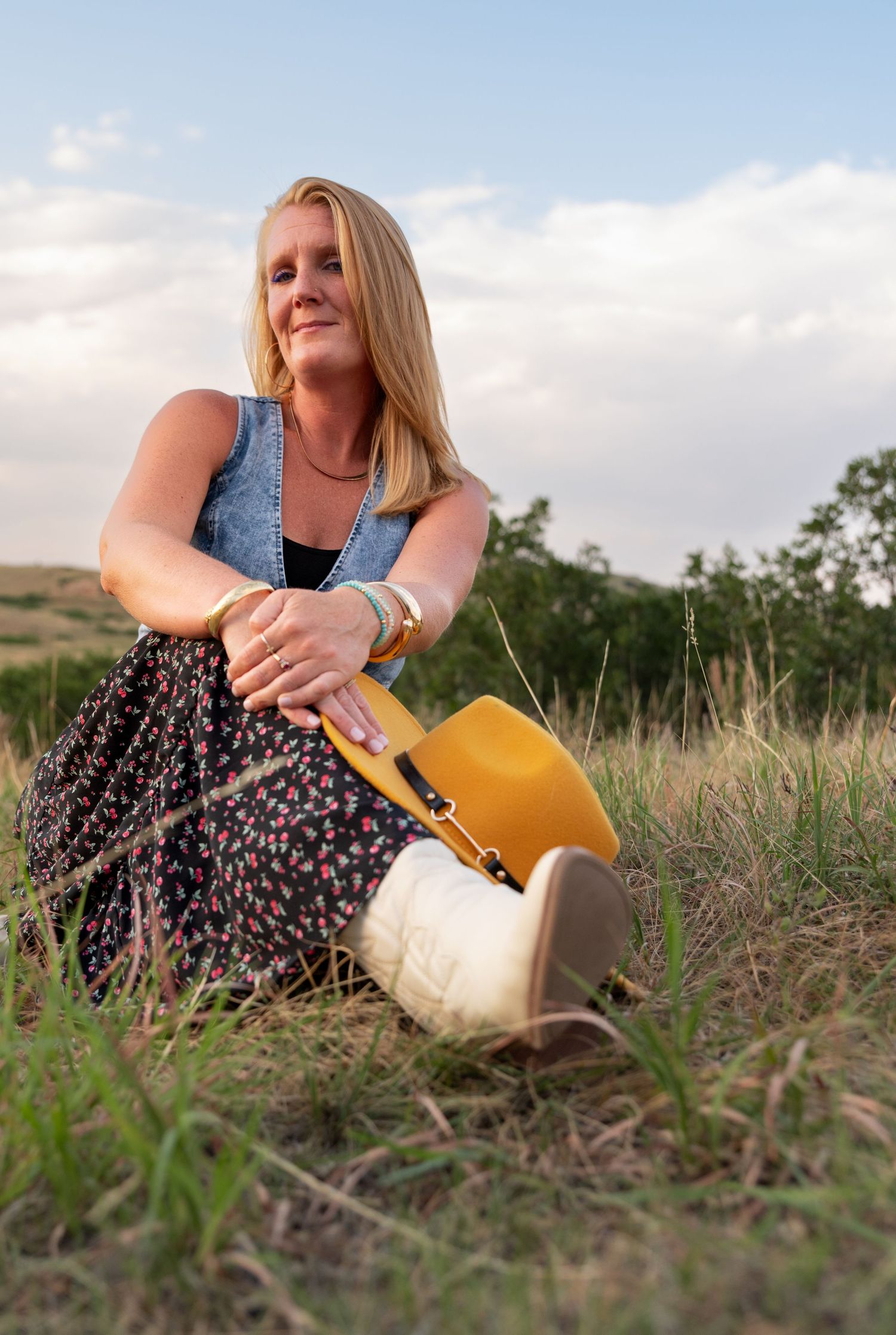 Photo of a woman sitting in the grass.  Photo by Elijah Grace Photo
