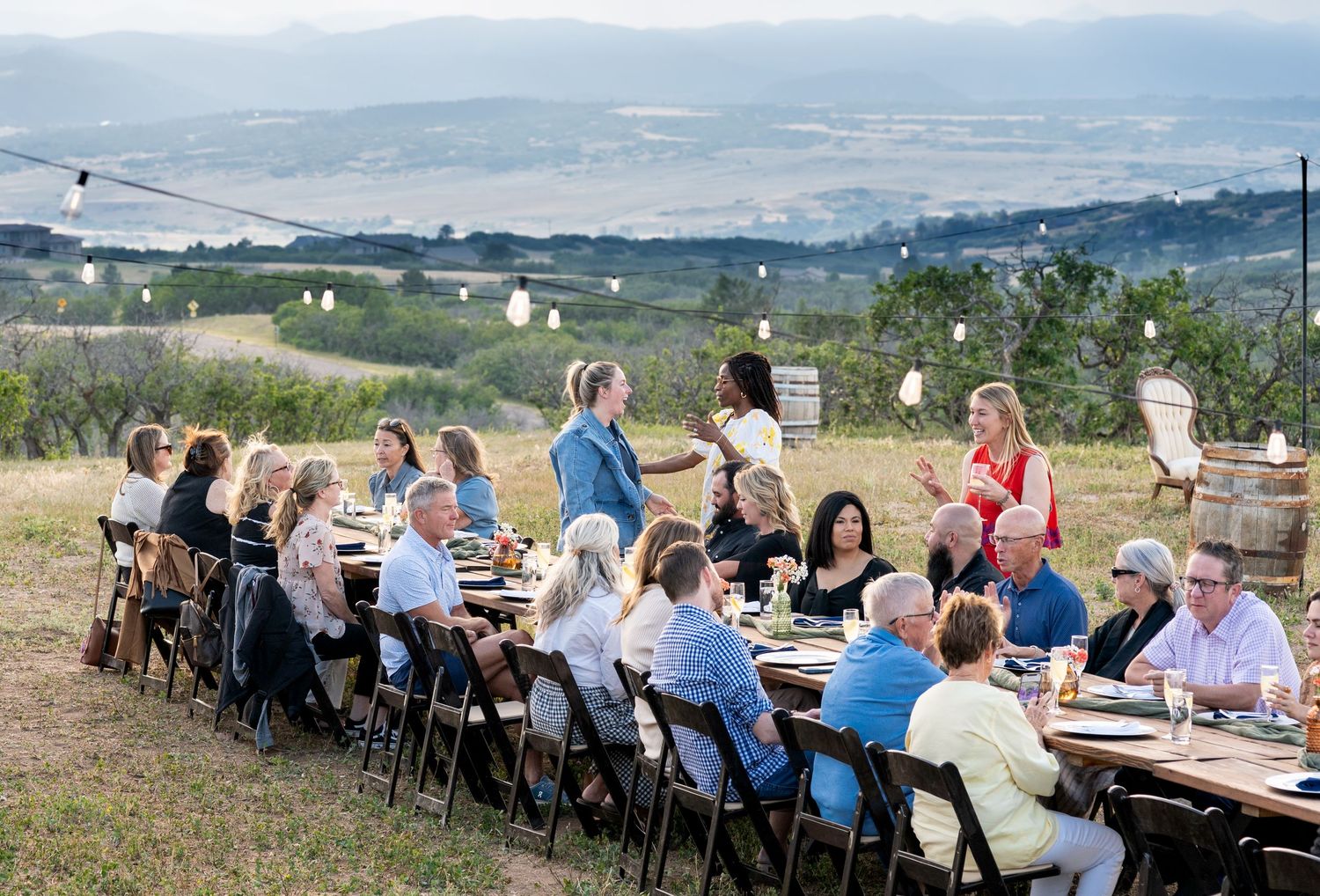 Outdoor dinner event with mountains in the background at KB Ranch