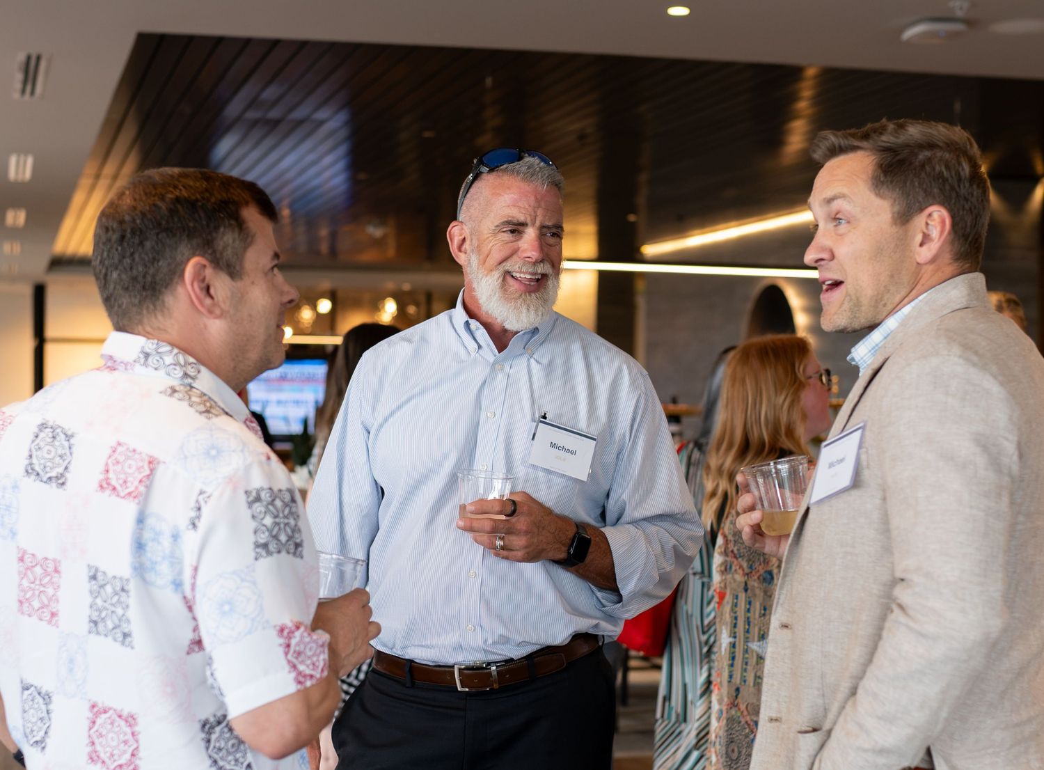 Professionals talking at Denver People Leaders Summer Soiree at Janus Henderson in Denver, CO