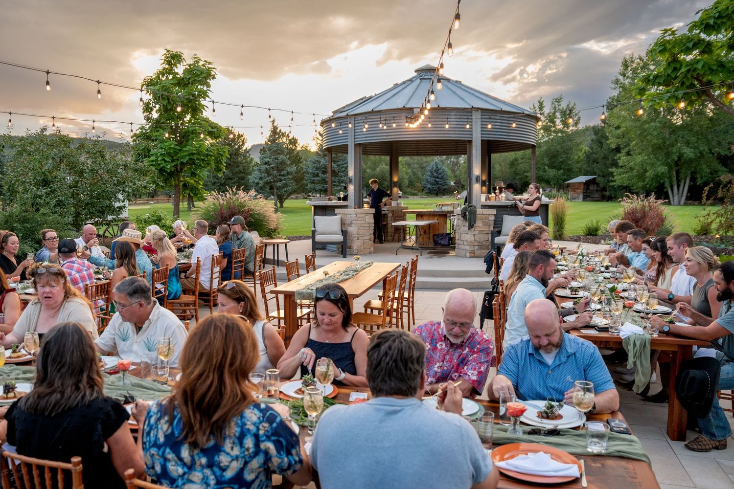 Outdoor event at sunset with outdoor lights at Lazy Stud Ranch in Lyons, CO.