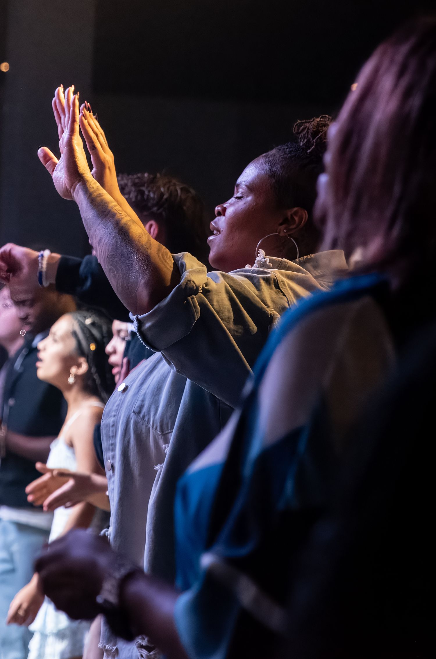 woman lifting her hands worshiping at Zeal Church, Colorado Springs. Photo by Elijah Grace Photo