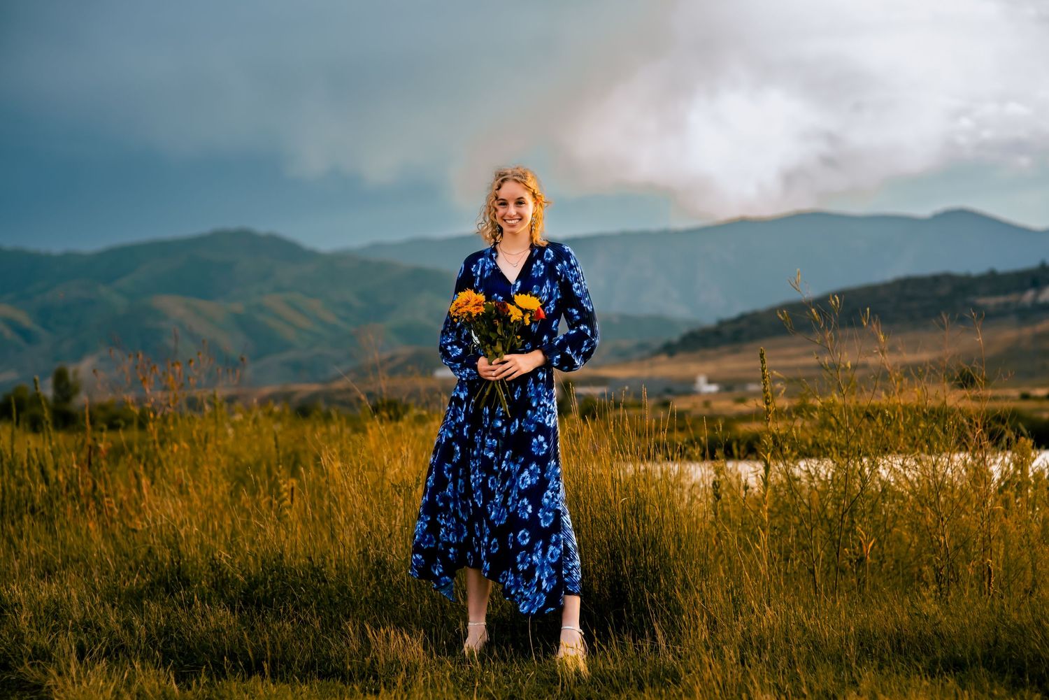Young lady at Chatfield State Park, posing for senior photos carrying flowers