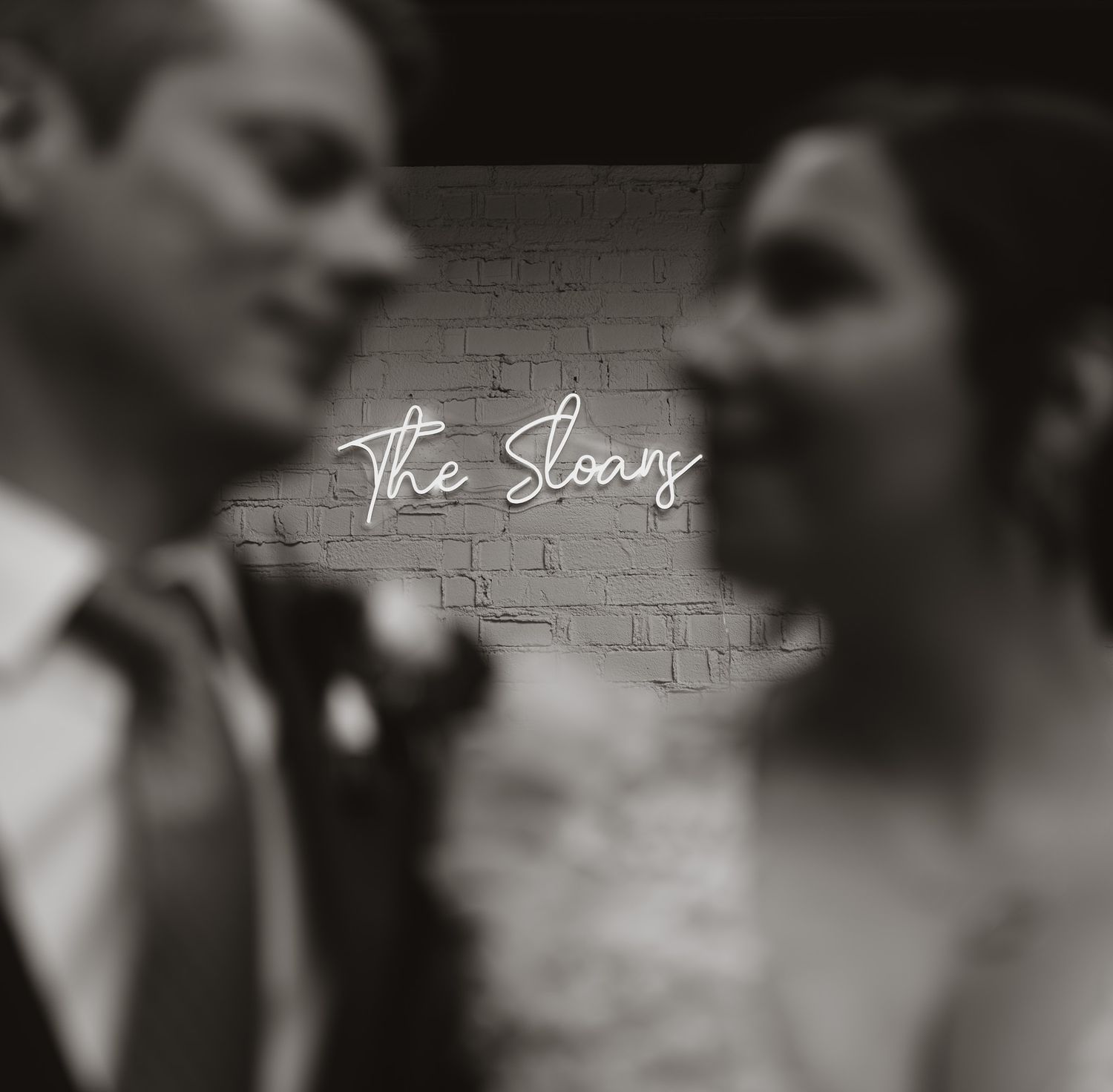 Close-up black and white artful portrait of a romantic embrace during a wedding ceremony.