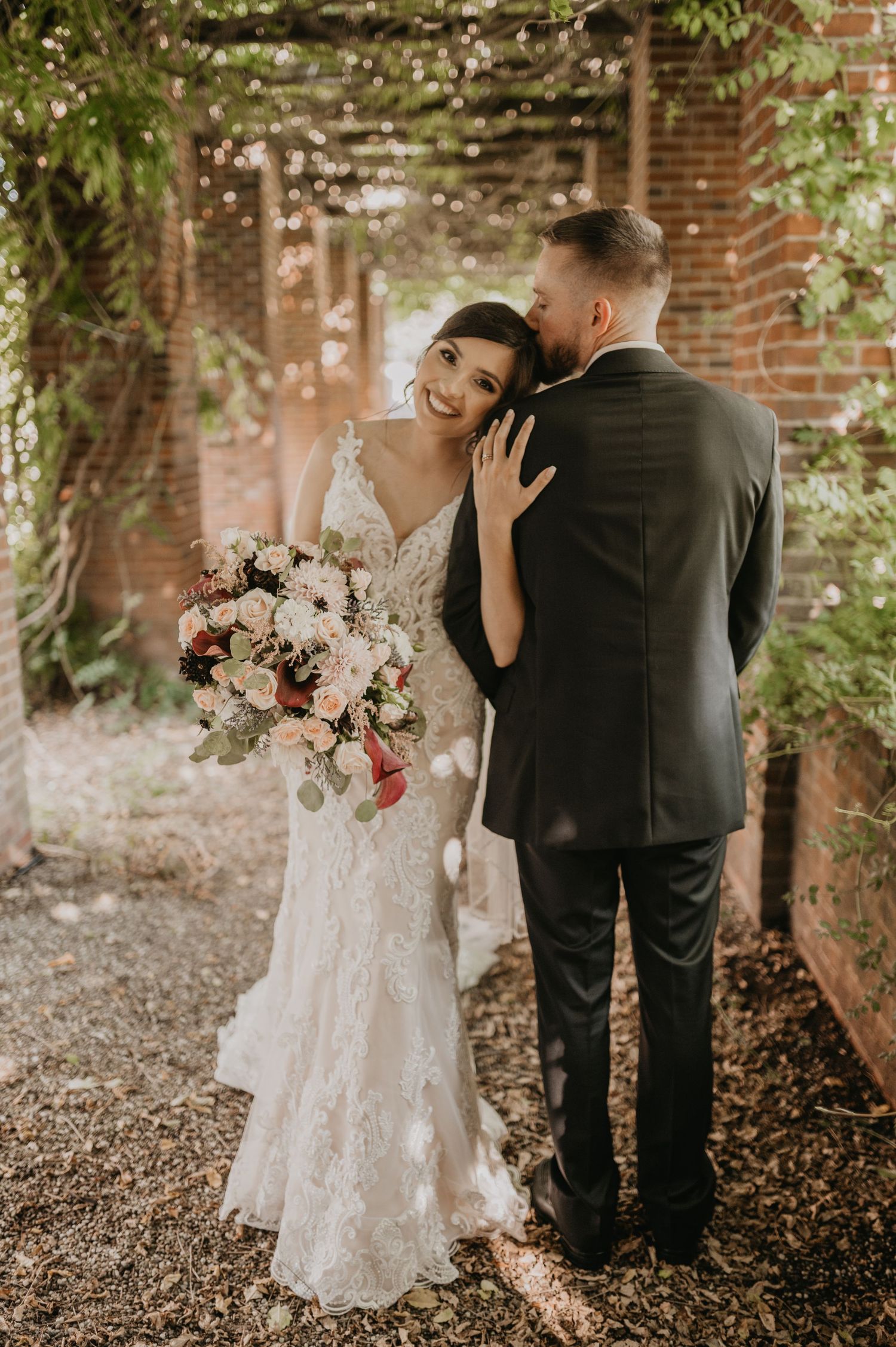 Wedding first look photos capture joyful reactions between couple in front of brick church walls.