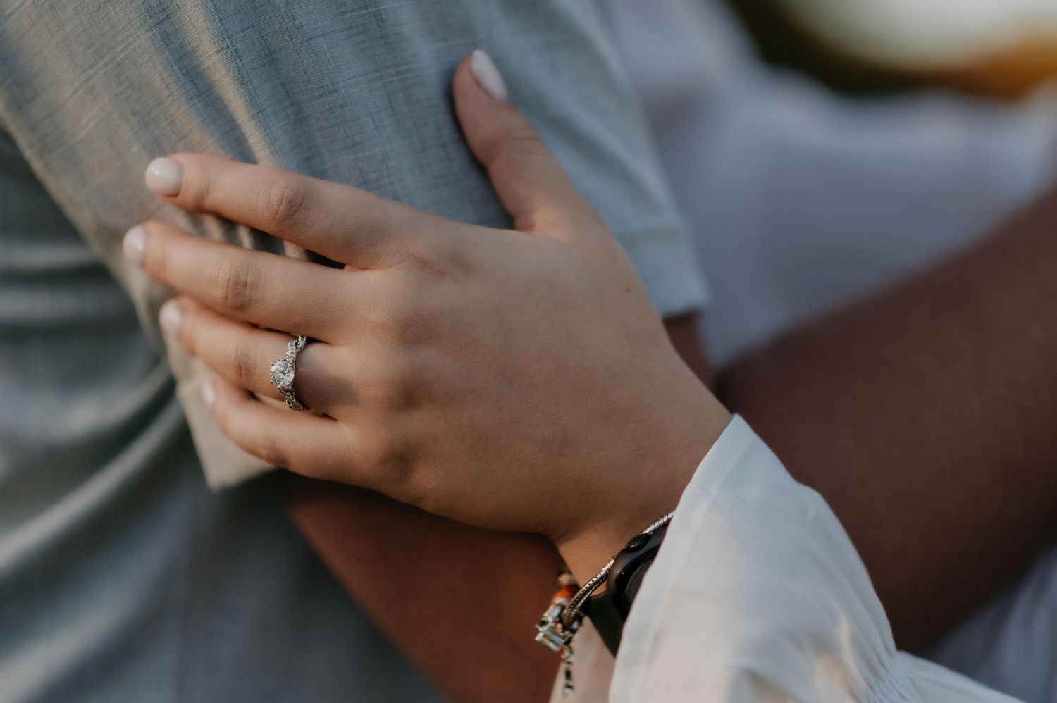 Close-up shot of hands exchanging wedding rings during a romantic ceremony.