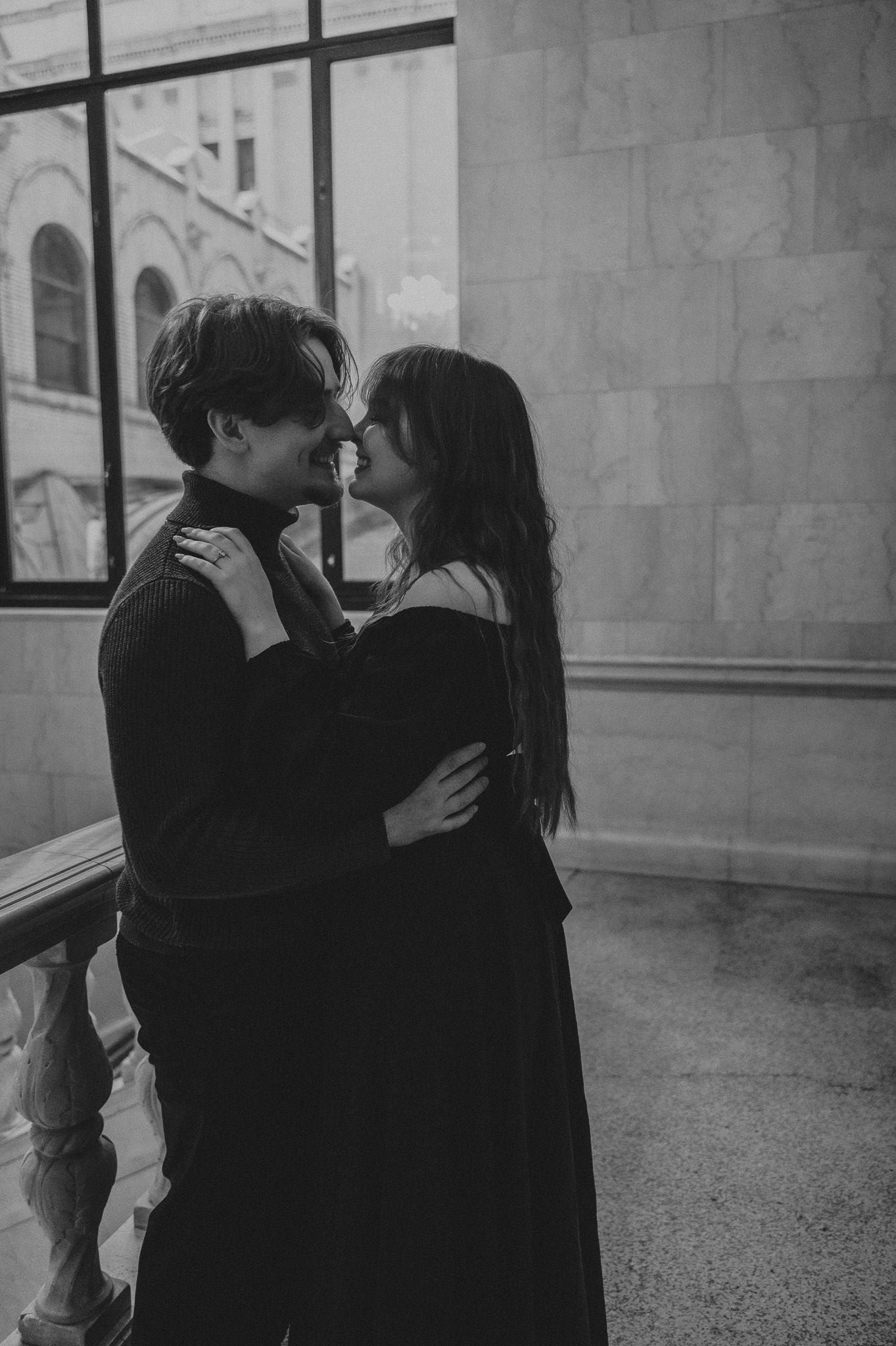 Black and white photo series showing a romantic moment between two people in a hallway.