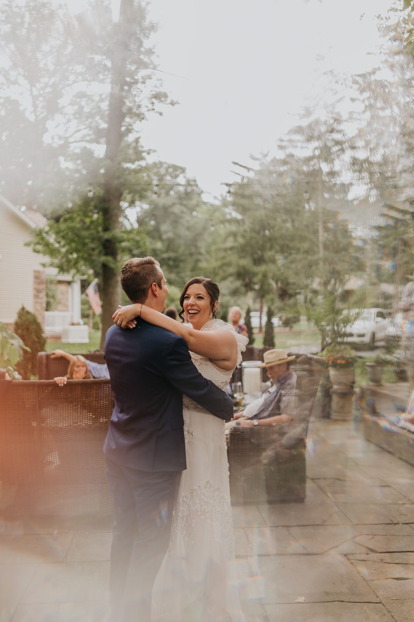 Romantic outdoor dance scene with couple embracing in foggy garden setting.