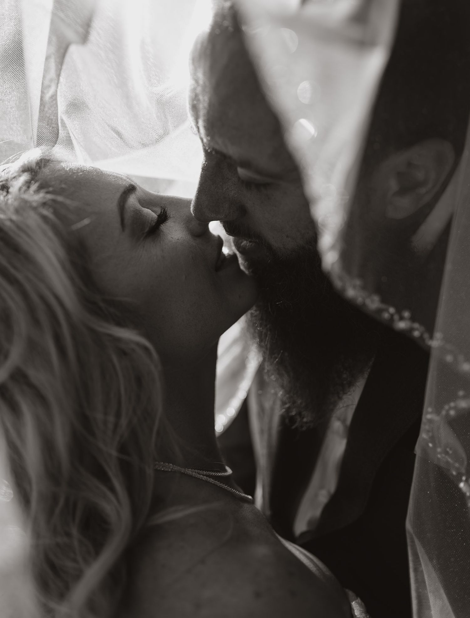 Atmospheric black and white wedding photos showing intimate moments between couple.