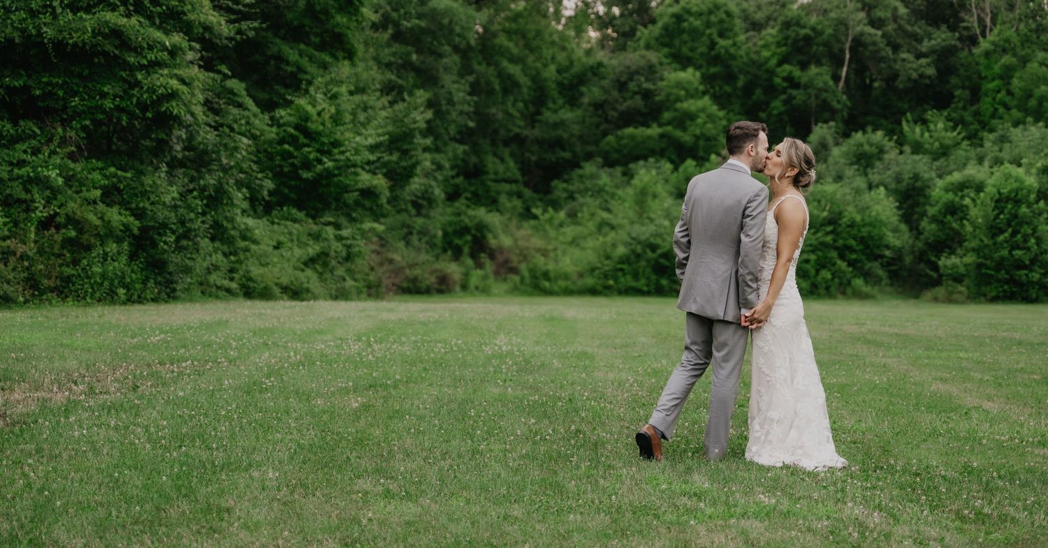 A lush green garden landscape serves as a beautiful outdoor wedding venue setting.