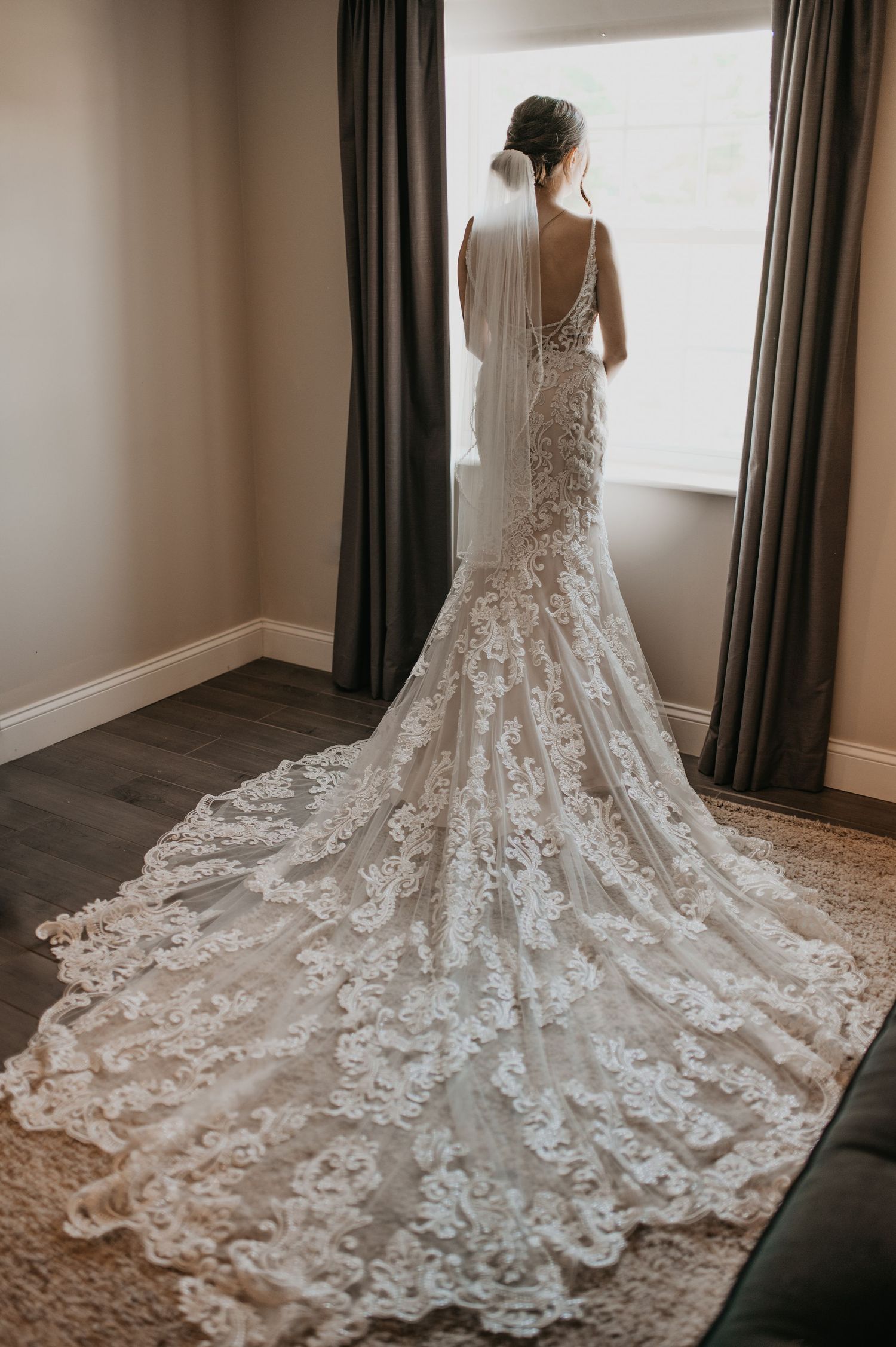 Stunning white lace wedding dress with intricate floral detailing and dramatic cathedral-length train shown from multiple angles.