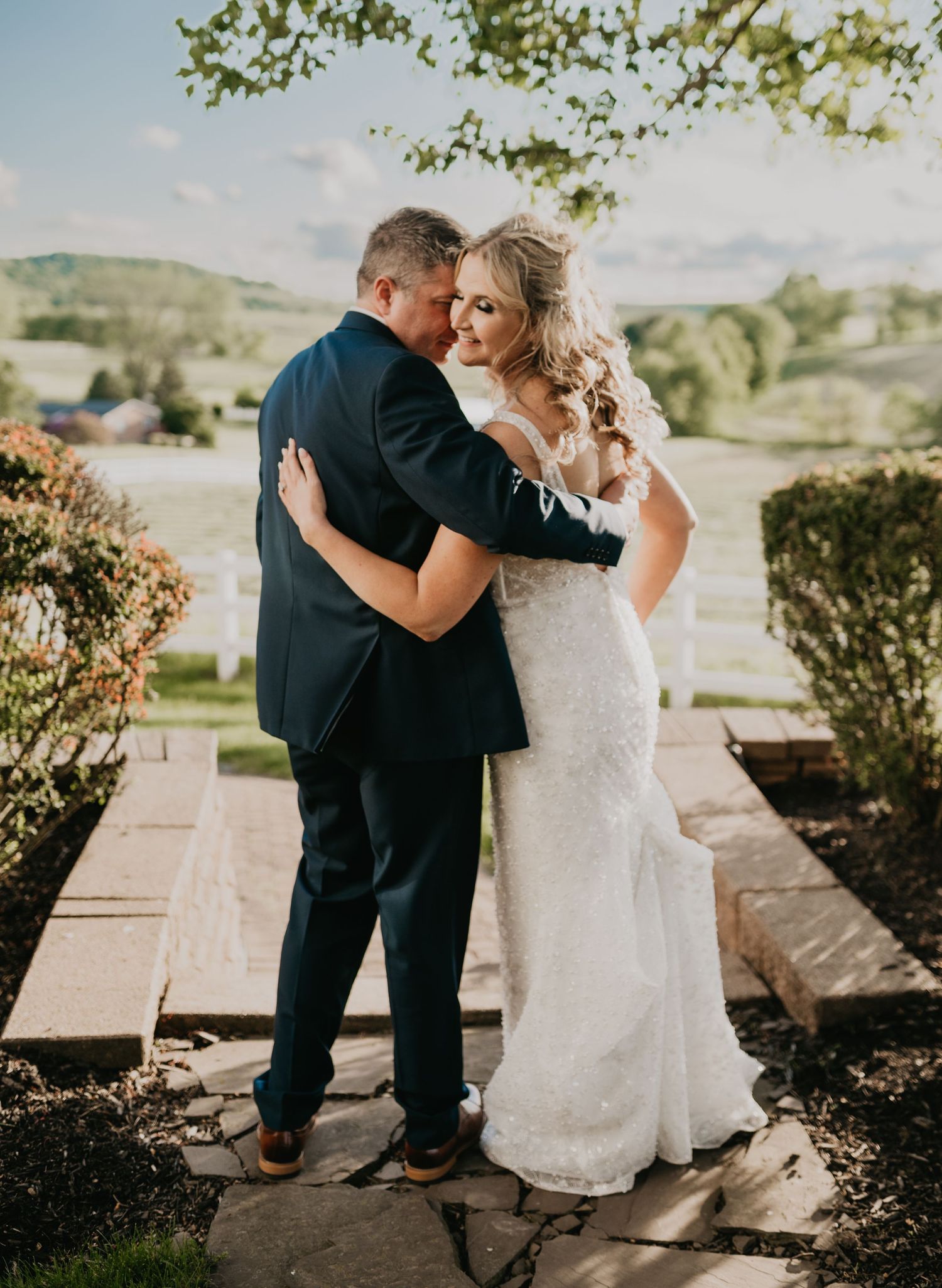 Romantic outdoor wedding portraits captured in a scenic mountain landscape at sunset with natural lighting and rustic charm.