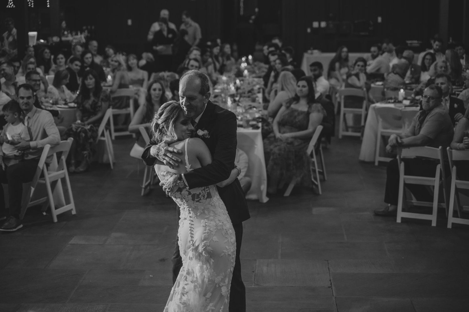 Wedding reception dance floor filled with guests celebrating at an indoor venue.