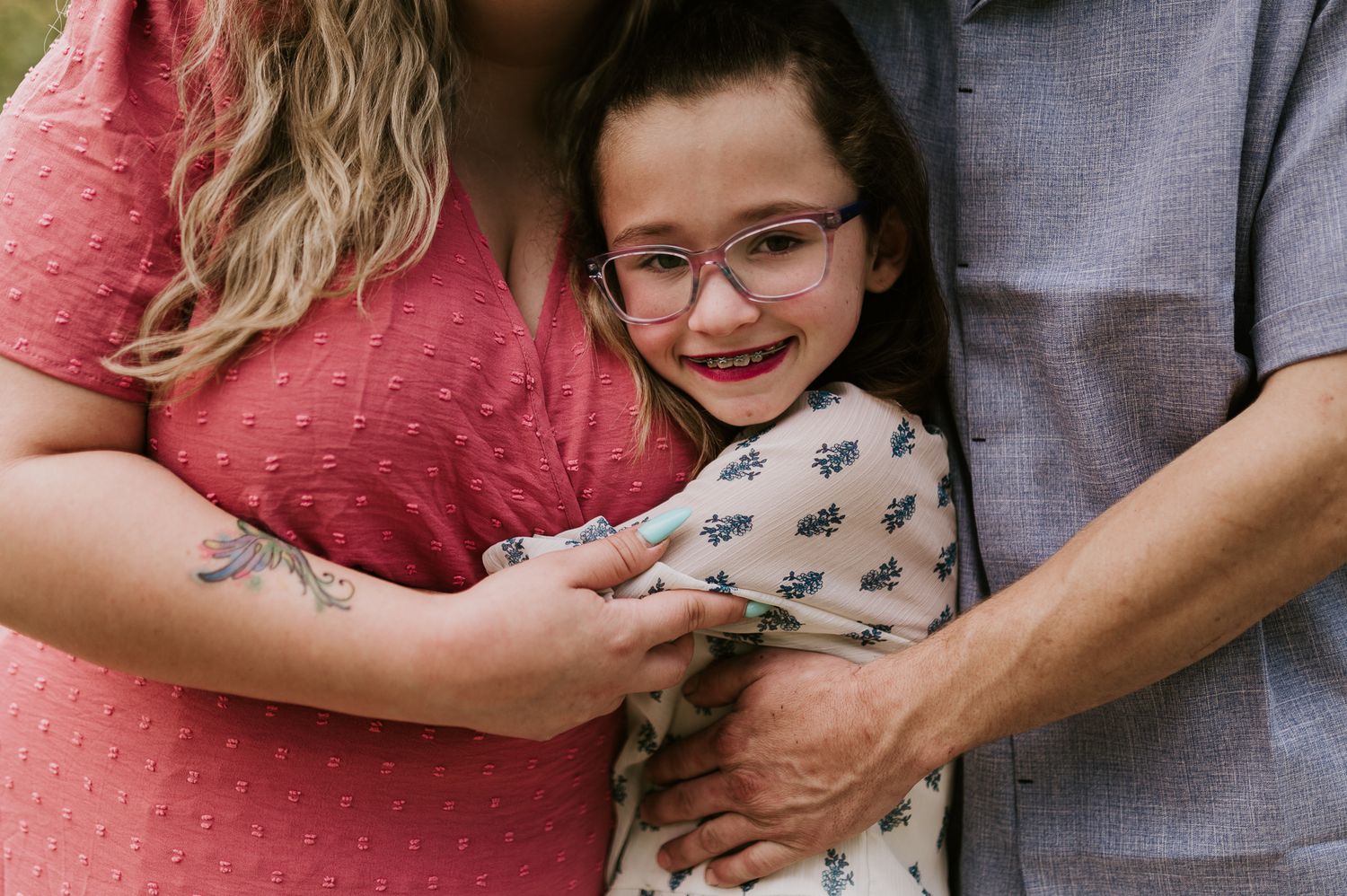 A close-up candid family moment captured with warm tones and tender embraces.