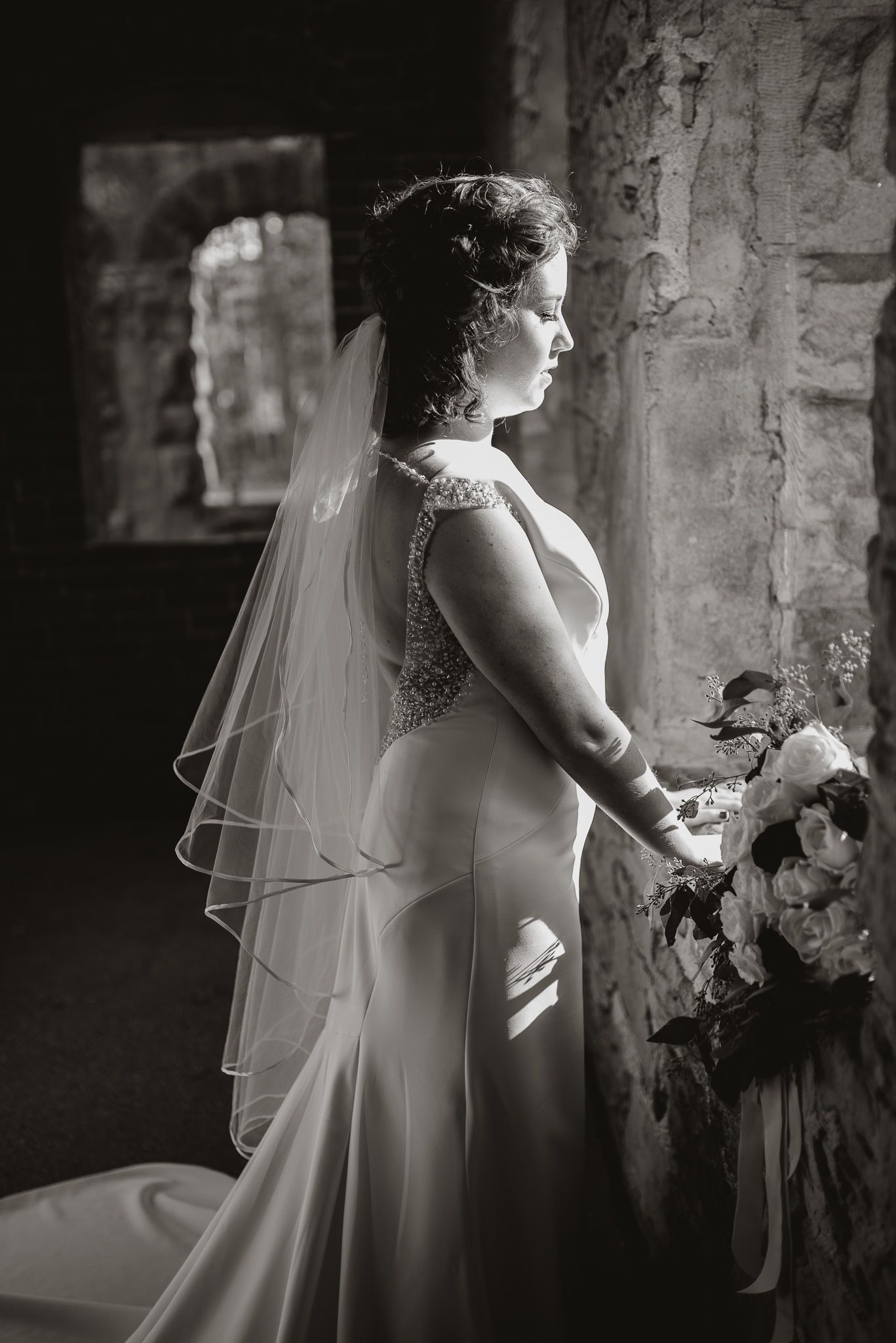 Black and white bridal portraits showing elegant details of wedding dress and veil.