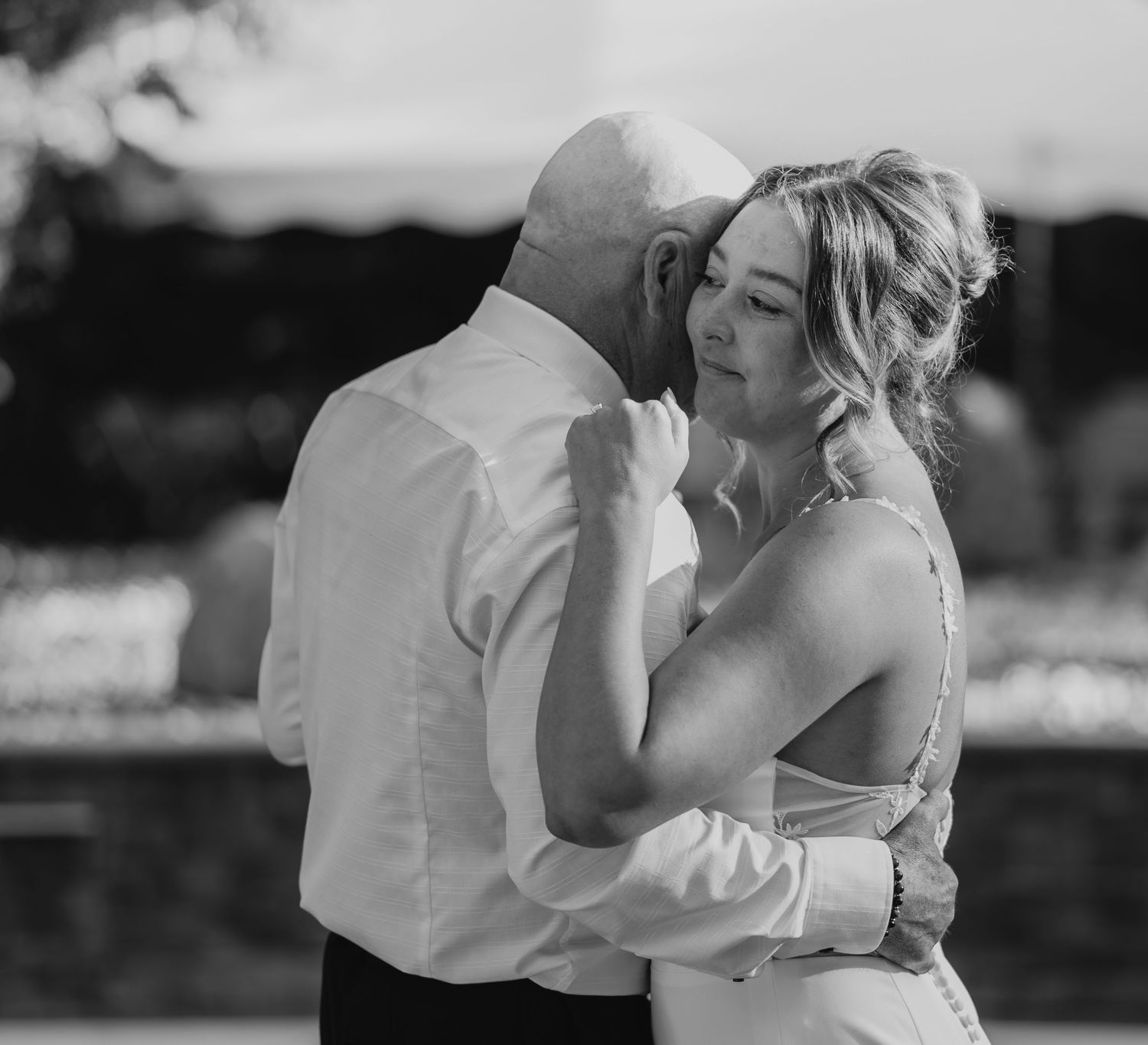 A romantic black and white photo series showing tender moments between a couple during their wedding celebration.