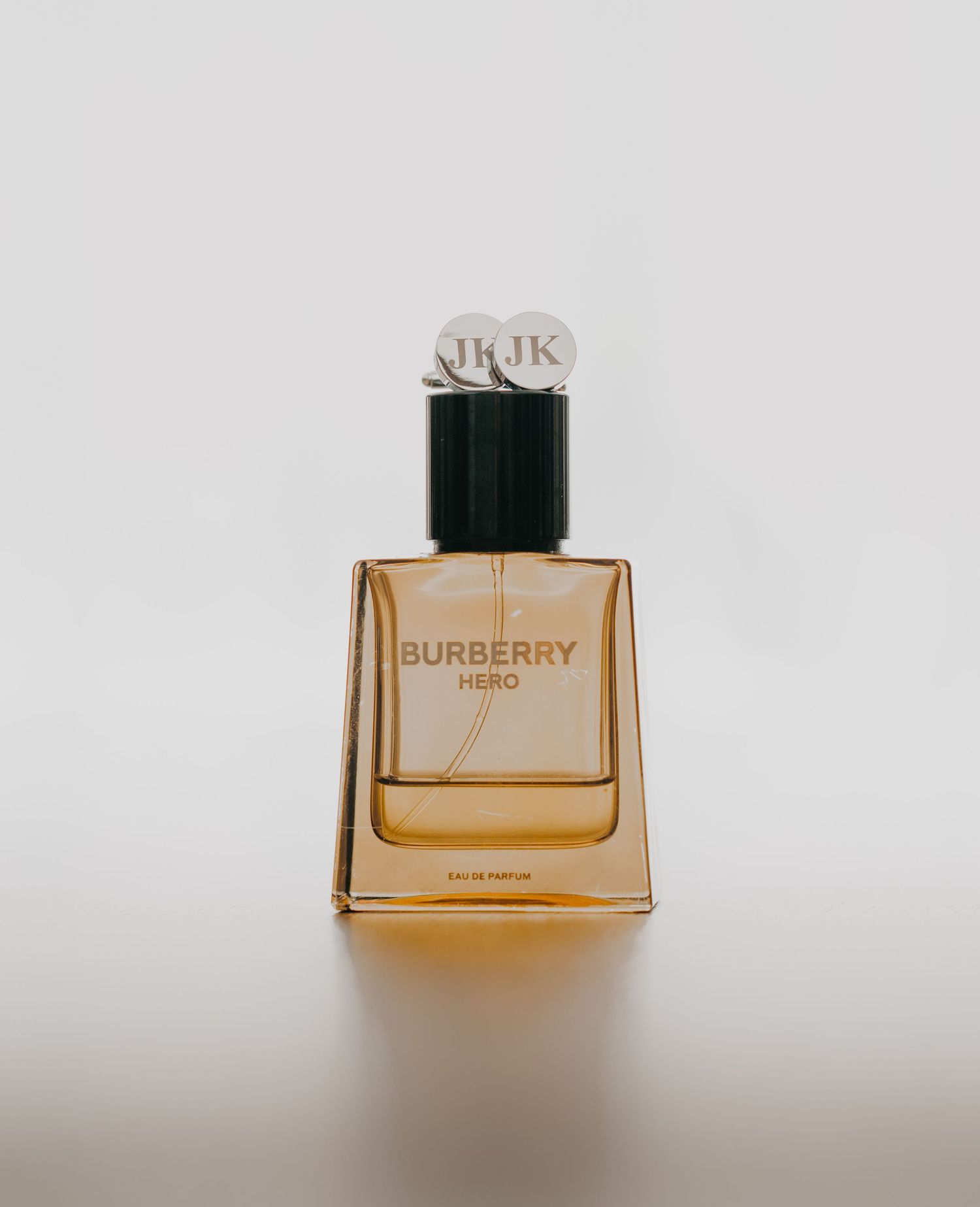 Multiple views of an amber-colored Burberry perfume bottle against a white background.