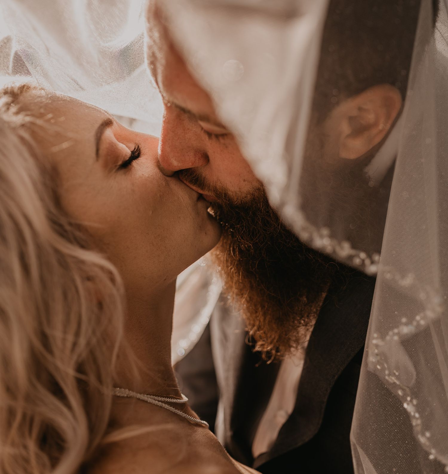 Sepia-toned wedding portraits capturing romantic close-ups of newlyweds.