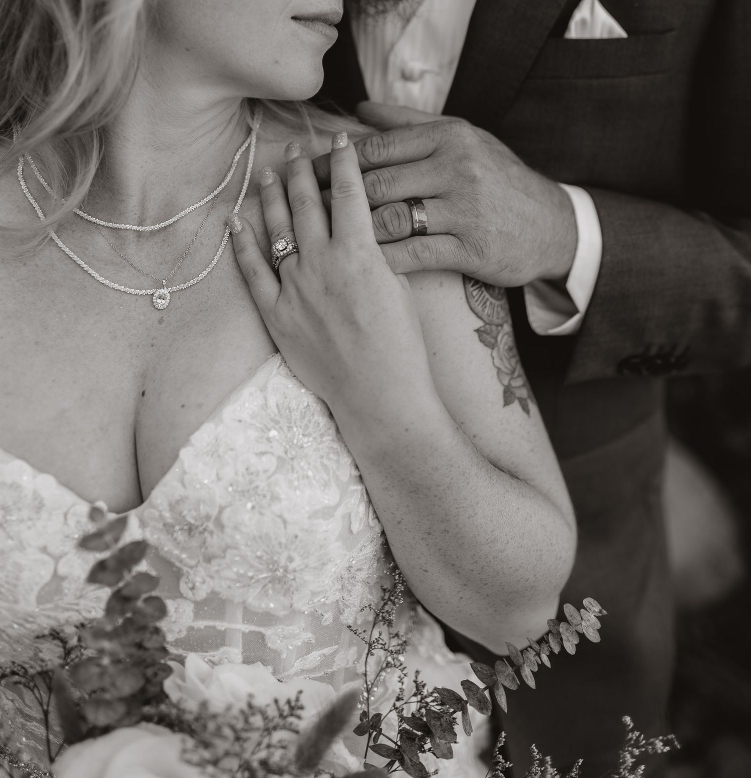 Artistic black and white wedding portraits capturing tender moments between newlyweds.