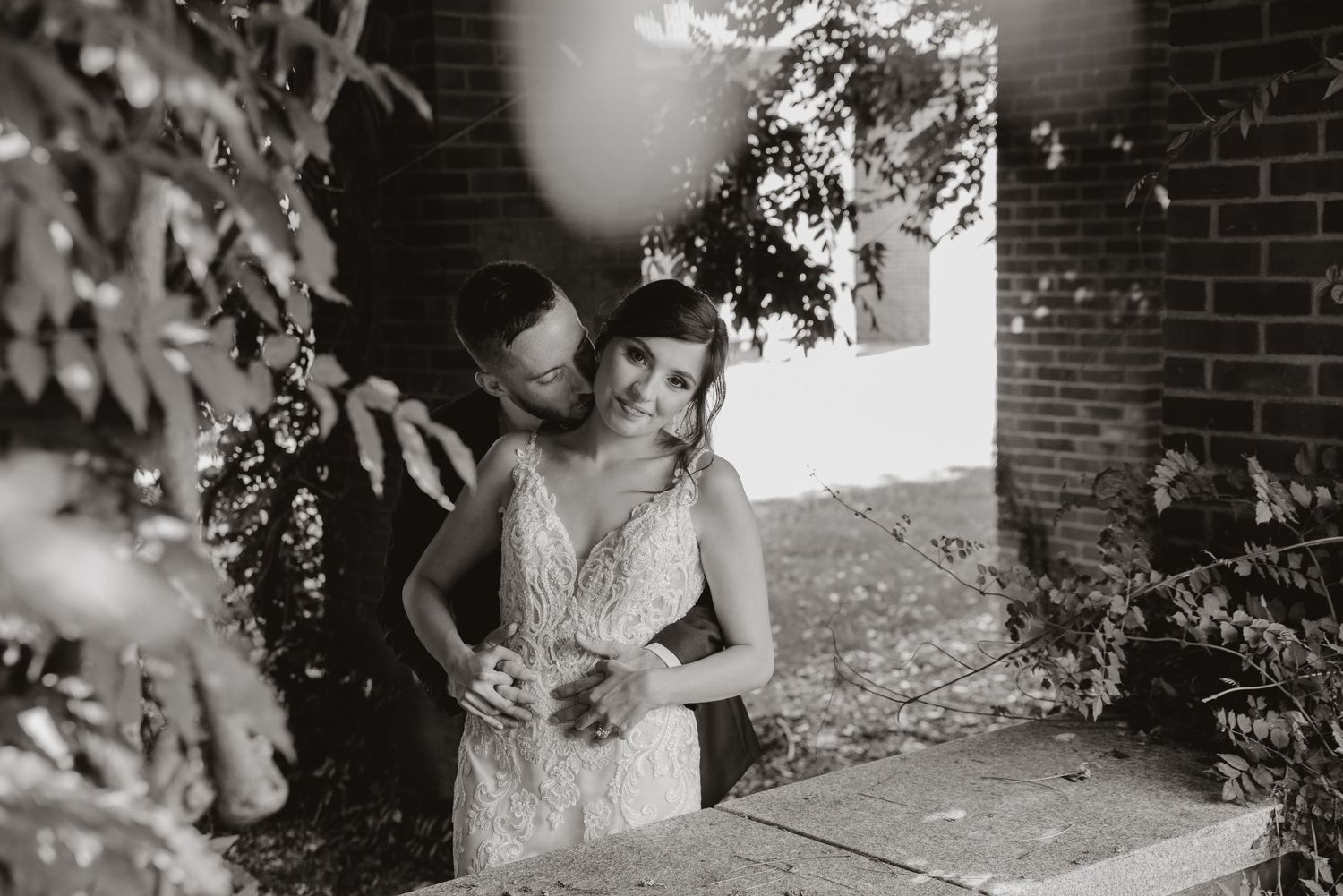 Detail shot of floral arrangements and wedding decor against brick wall.