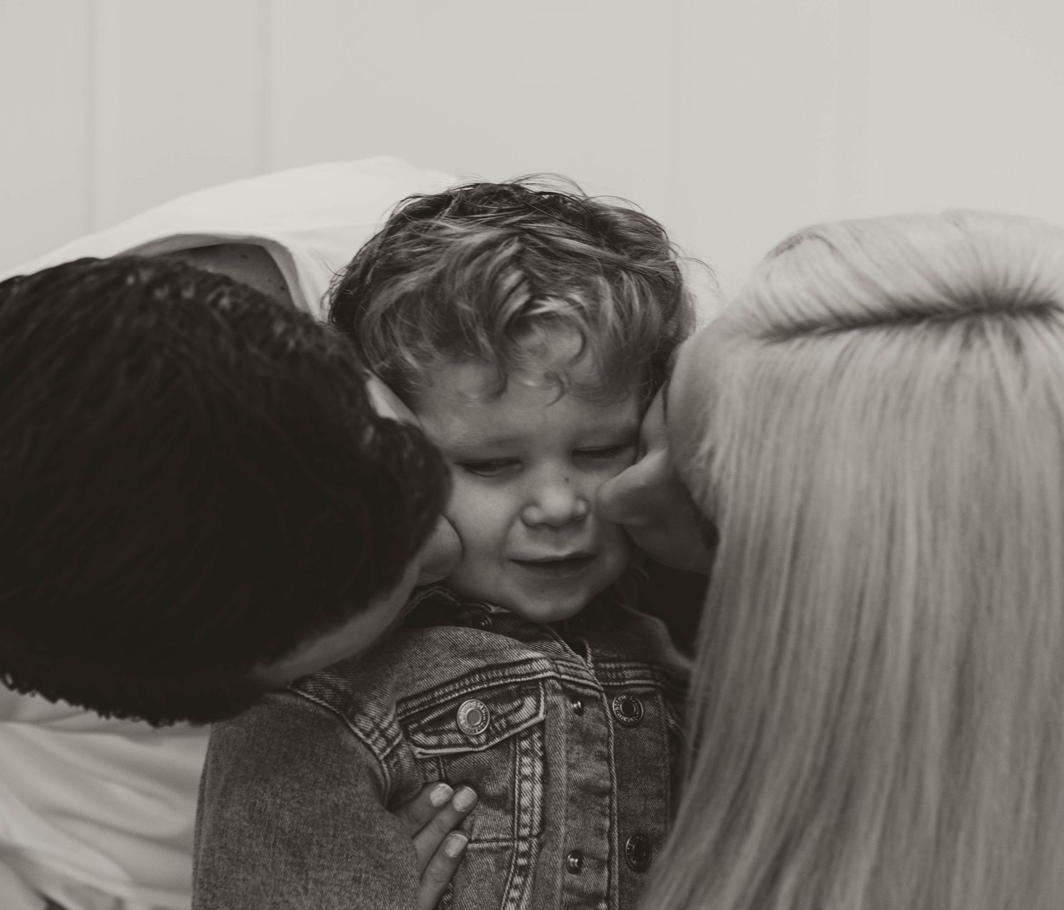 A collection of seven retro black and white film photos arranged in a series showing candid emotional moments.
