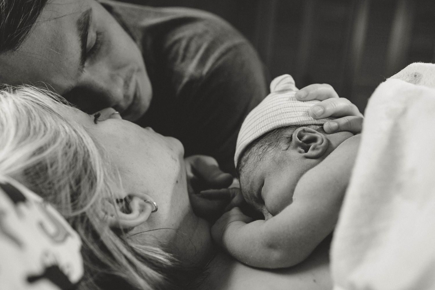 A peaceful black and white photograph shows sleeping figures cuddled together in tender repose.
