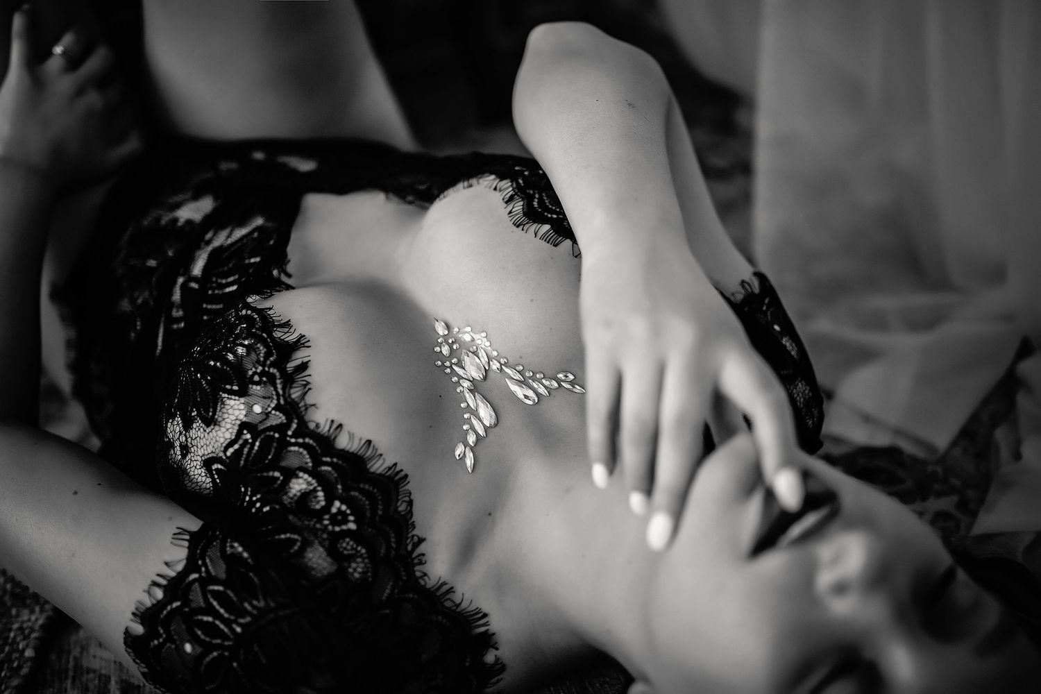 Black and white boudoir portrait close up of hands and crystals