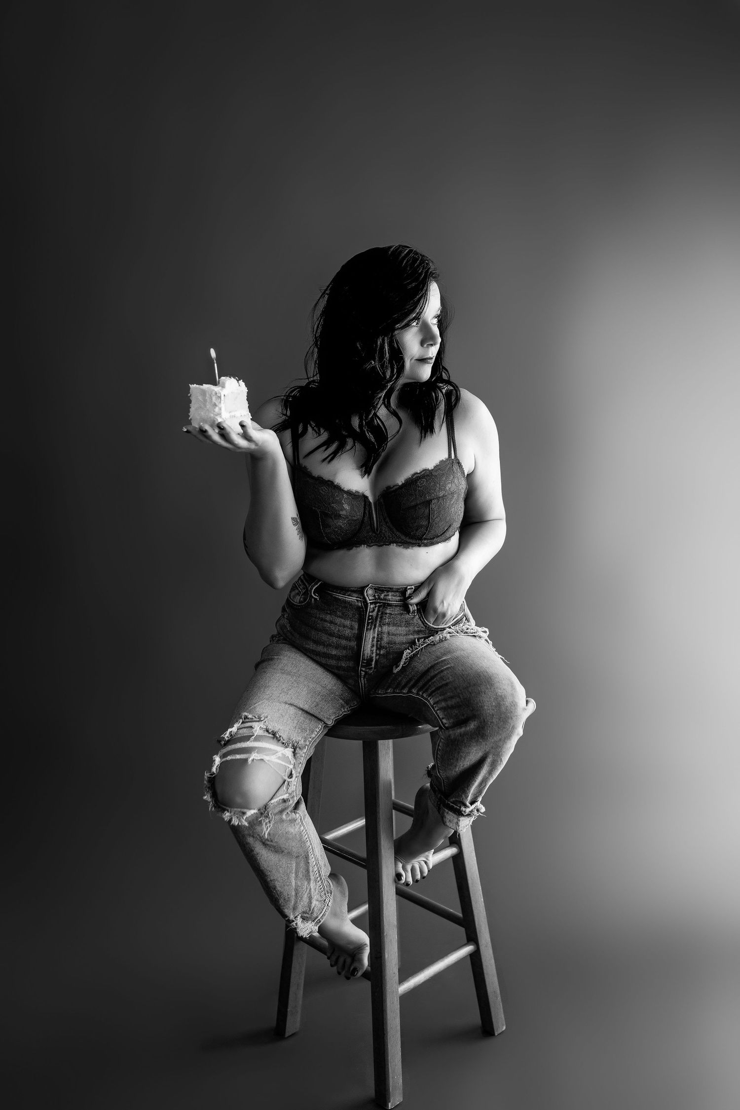 Indianapolis Indiana black and white portrait of client on stool holding a slice of cake