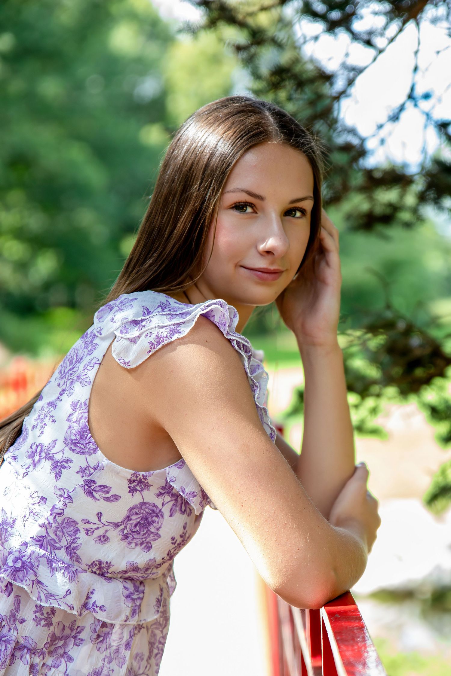 A floral dress photoshoot in a garden setting with soft natural lighting.