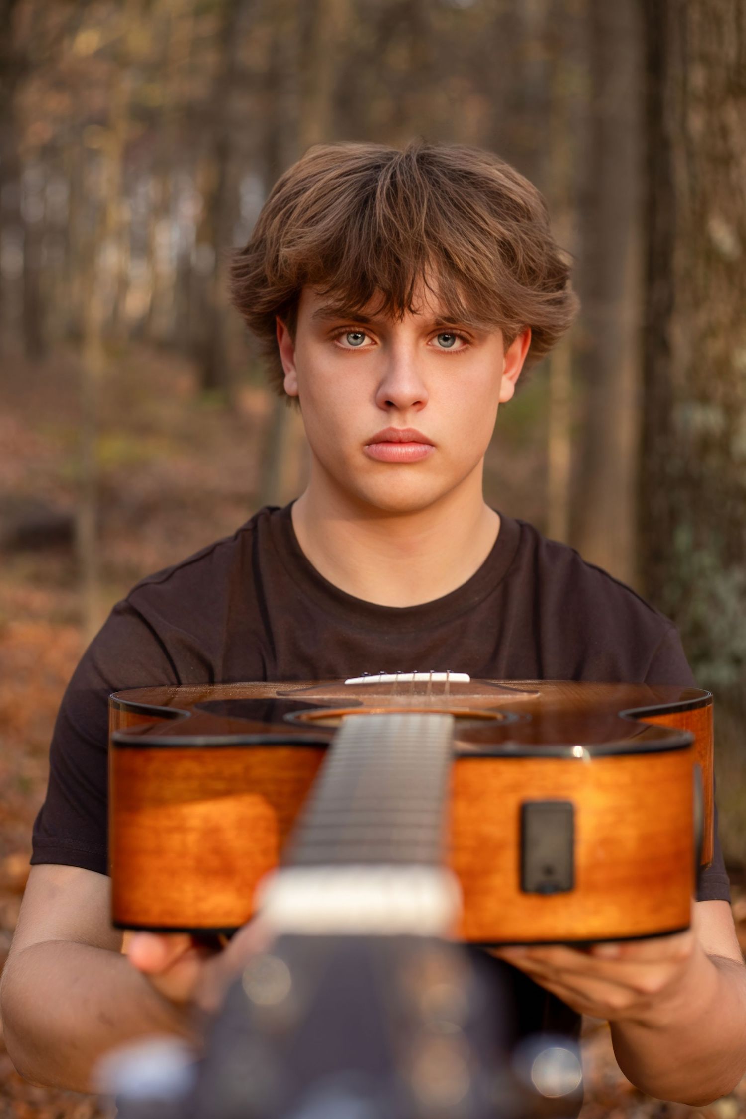 Close-up shots of a violin being held in warm lighting against a natural background.