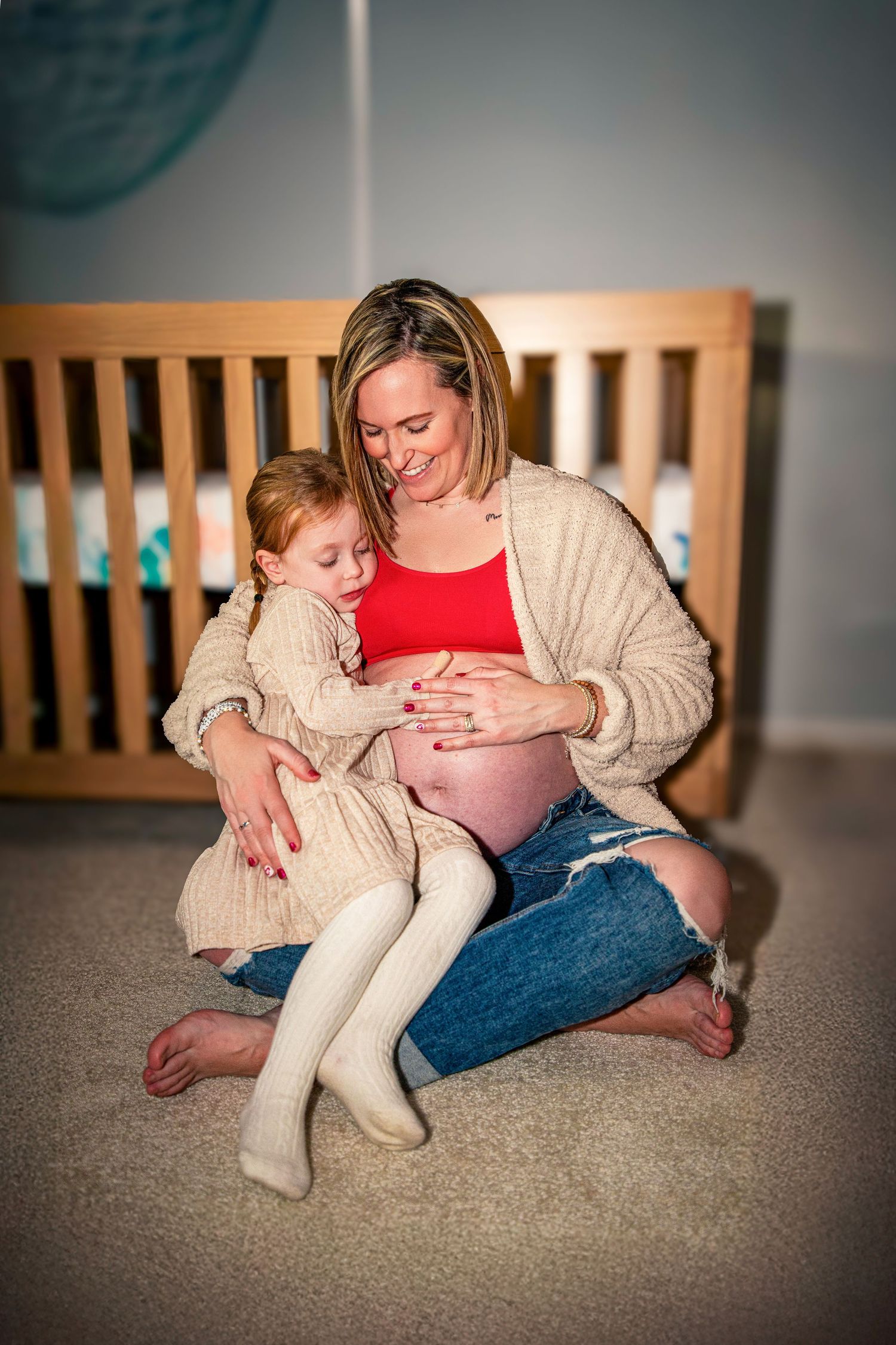 Candid lifestyle photography session on carpeted floor showing tender family moments.