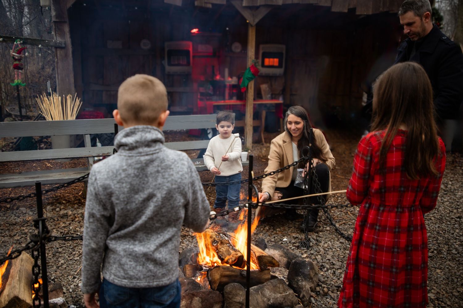 Group gathered around an outdoor fire pit on a cozy fall evening.