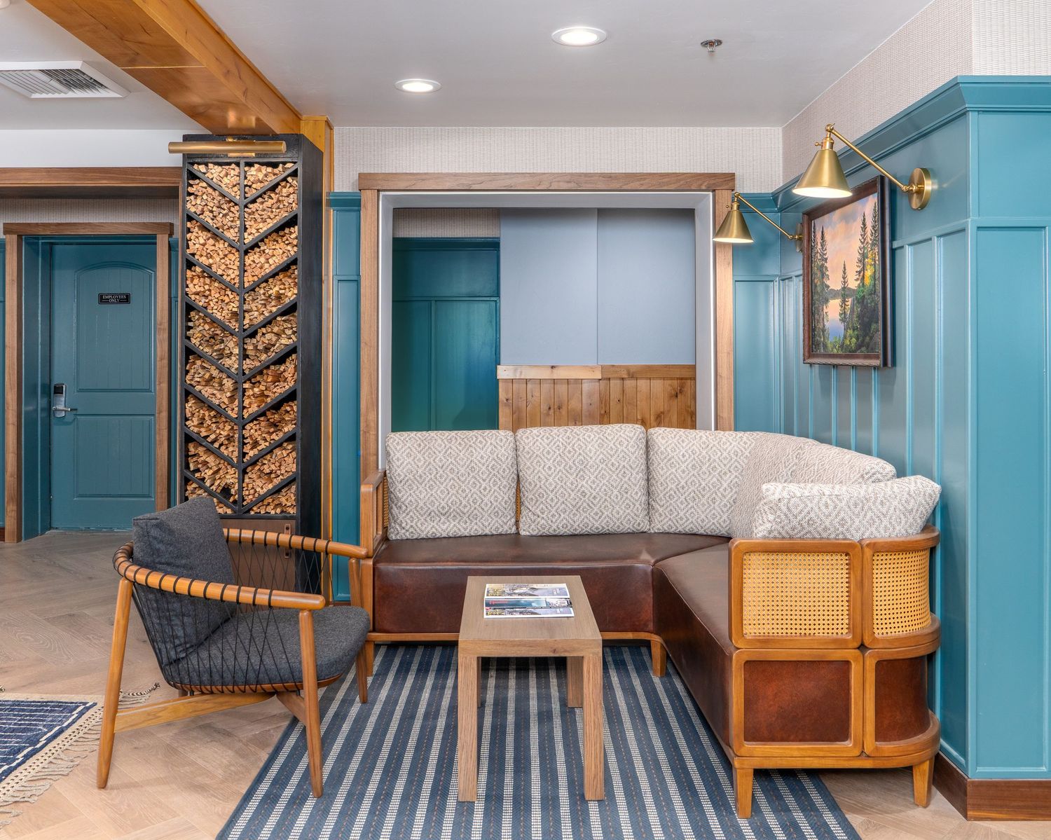 Modern coastal-style hotel room interior with turquoise walls, wooden accents, and striped carpet features built-in seating.