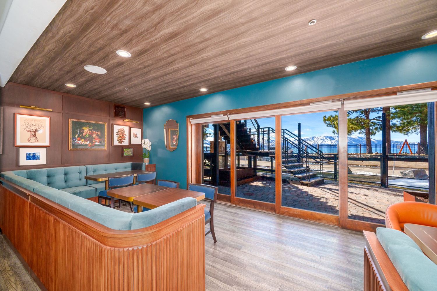 Modern fitness center interior with wood flooring, mirrored walls, and cardio equipment arranged in rows.