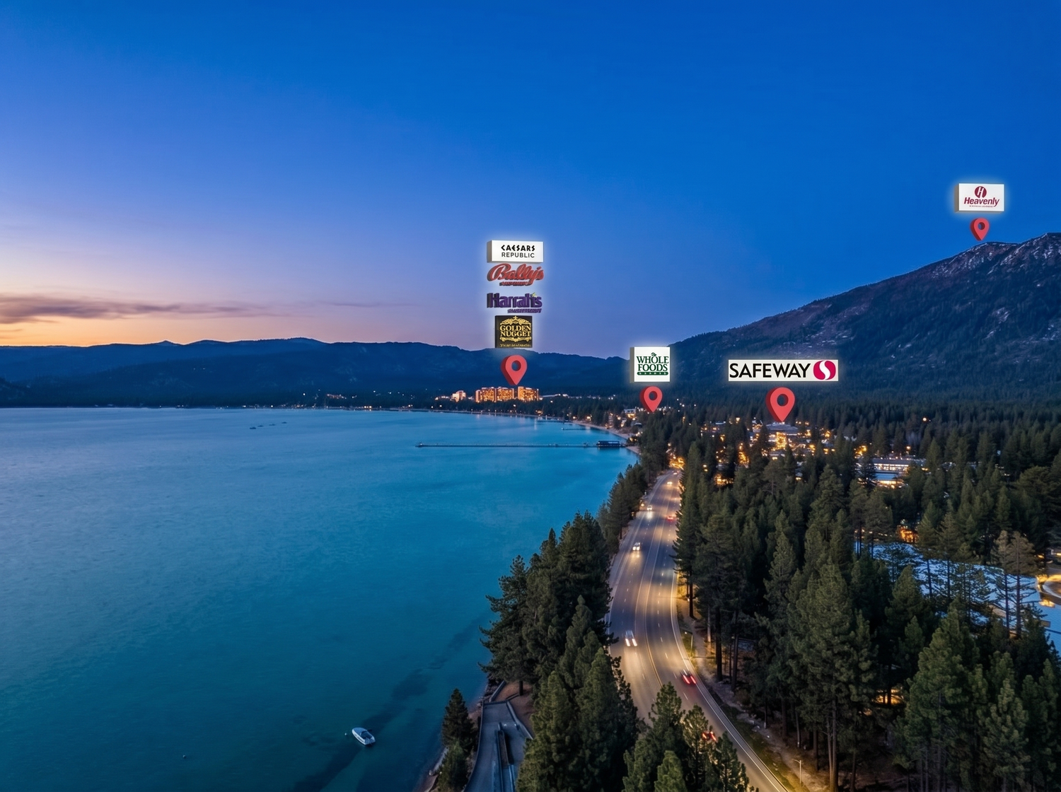Aerial twilight view of Lake Tahoe shoreline with Safeway and retail store signs visible along a tree-lined highway.