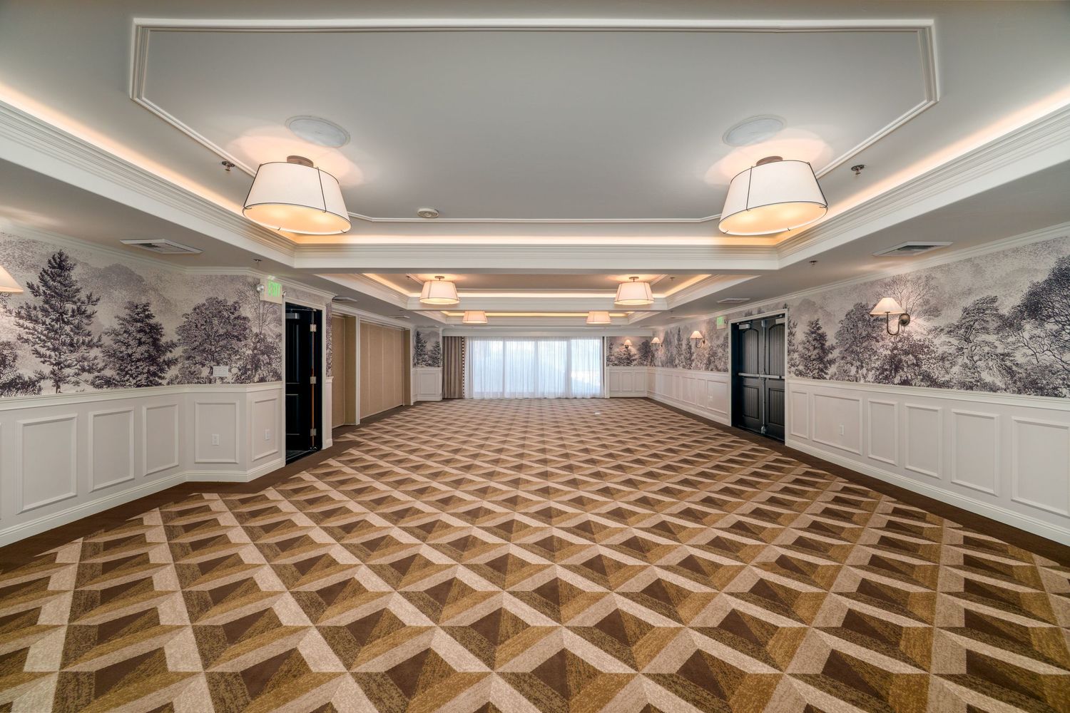 Architectural details of a modern ballroom ceiling with recessed lighting and geometric patterns.