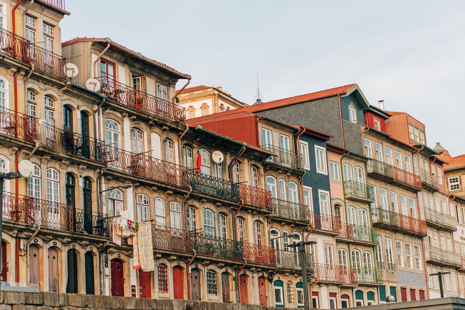 Colorful historic building facades with ornate balconies in Porto, Portugal.