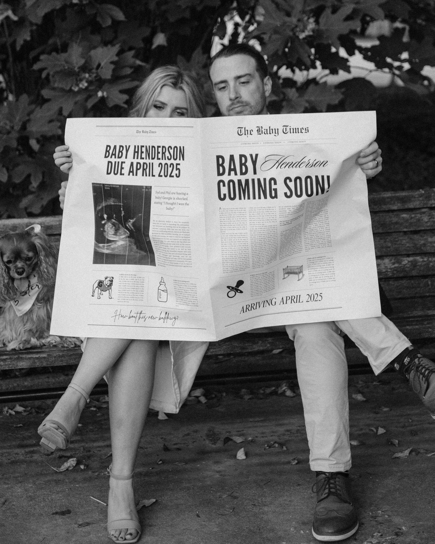 Black and white photo of a couple on a bench holding a Baby Times newspaper announcing Baby Henderson due April 2025.