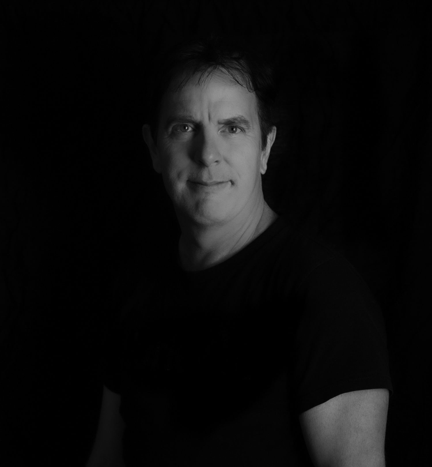 Black and white professional portrait of a San Diego creative professional with dramatic studio lighting