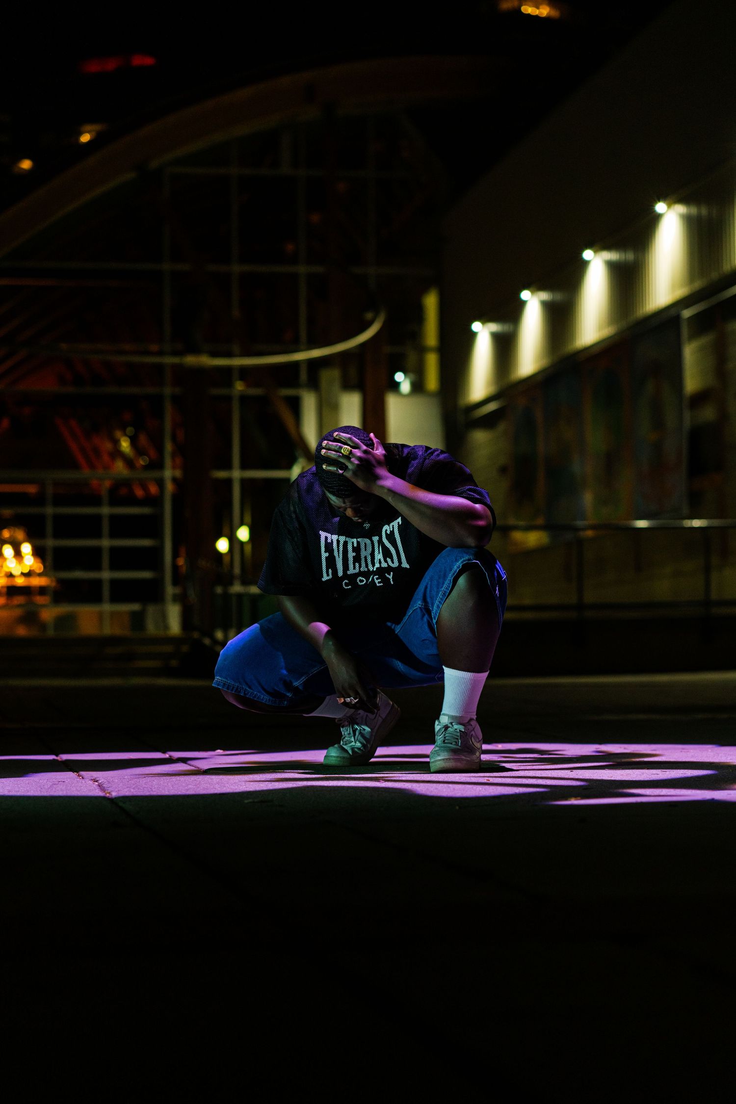 Boxing gloves and equipment illuminated in dramatic lighting on a dark background.