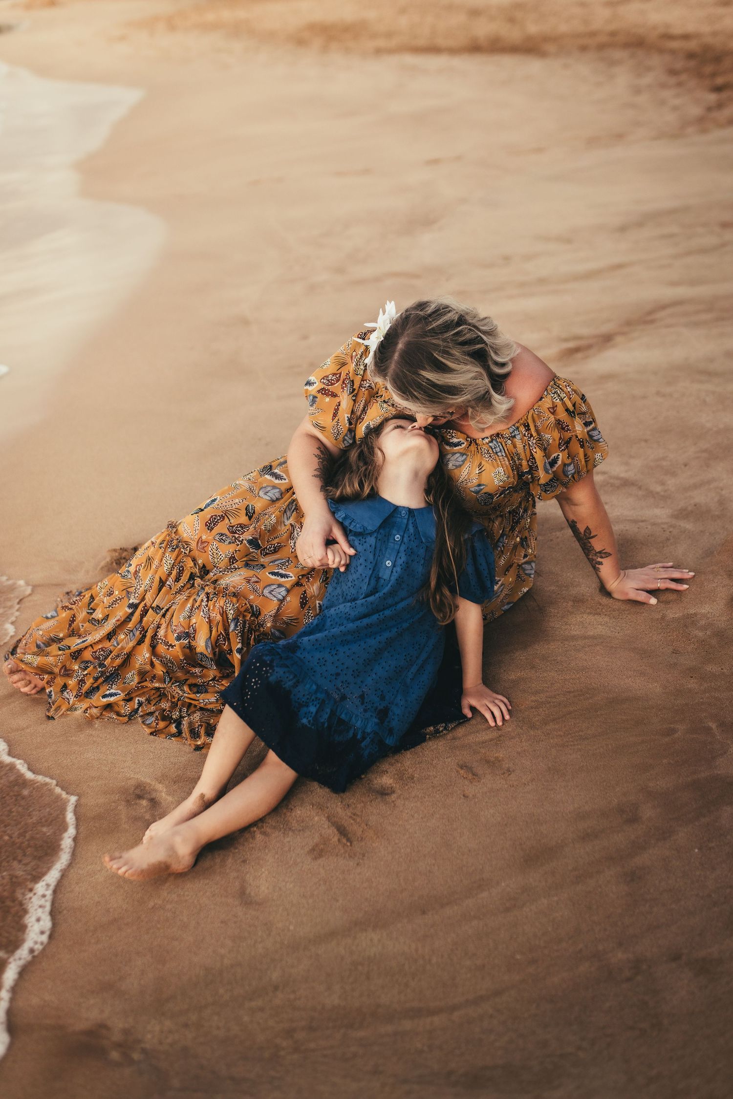 Marietta photographer and daughter share a moment on a sandy beach.