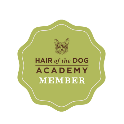 Hair of the Dog Academy Member badge, a green scalloped seal with a dog wearing glasses logo.