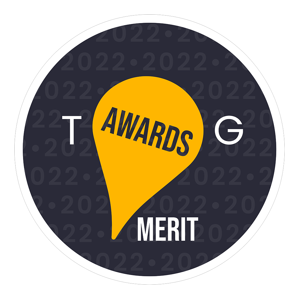 TG Awards 2022 Merit badge, circular dark navy design with gold location pin graphic and white typography.