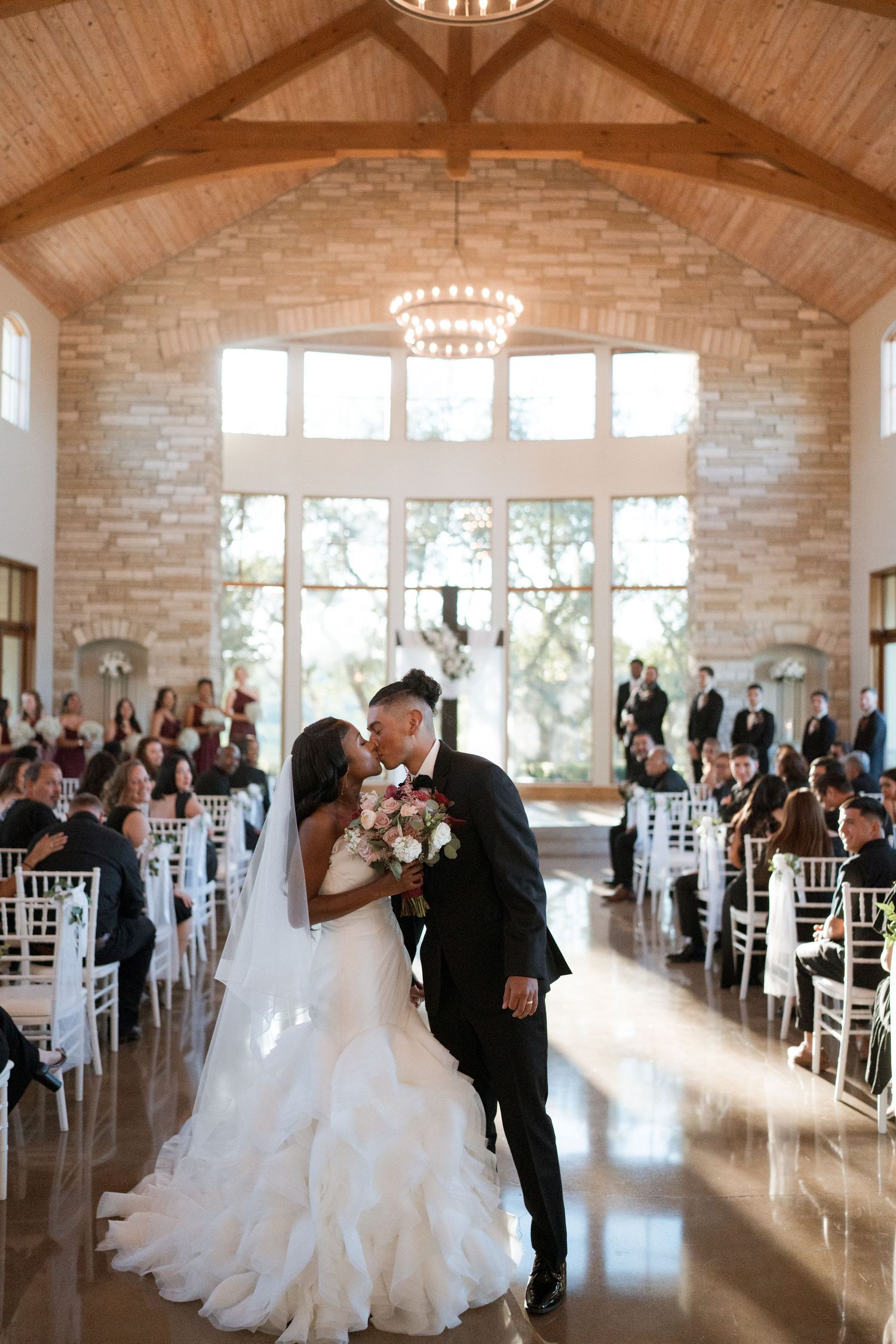 canyonwood ridge bride and groom kiss down aisle