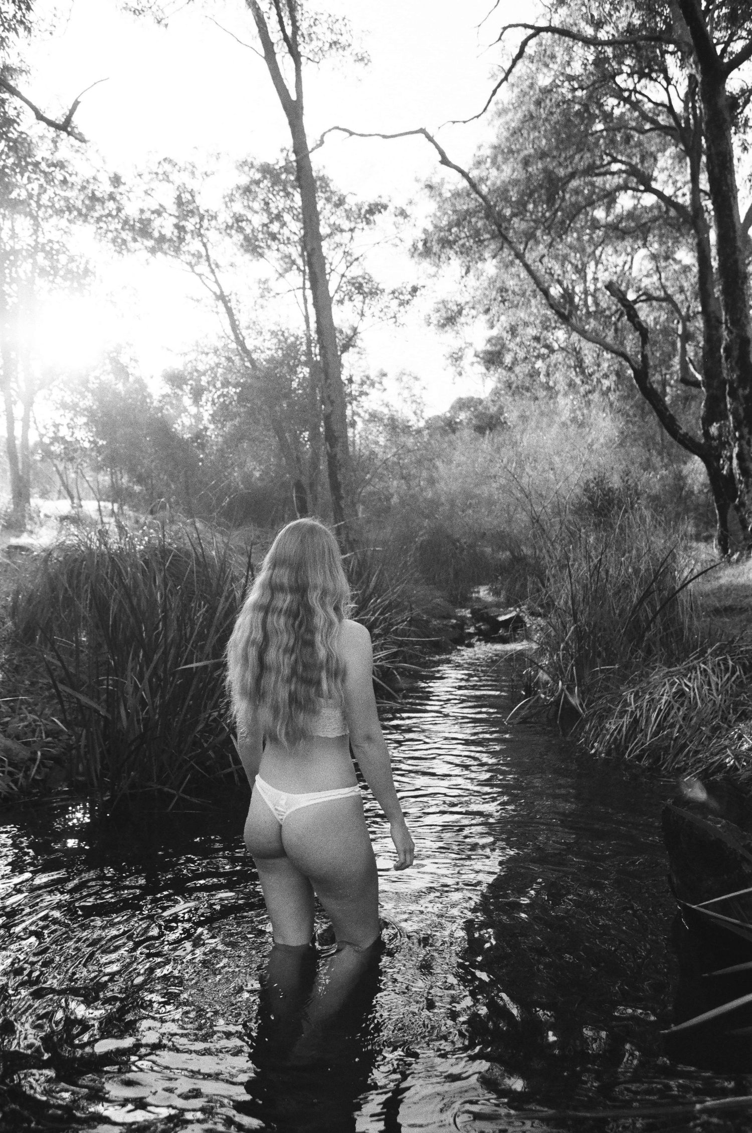 Film portrait of woman in quiet reflection at Lesmurdie Falls, serene natural light near Perth”