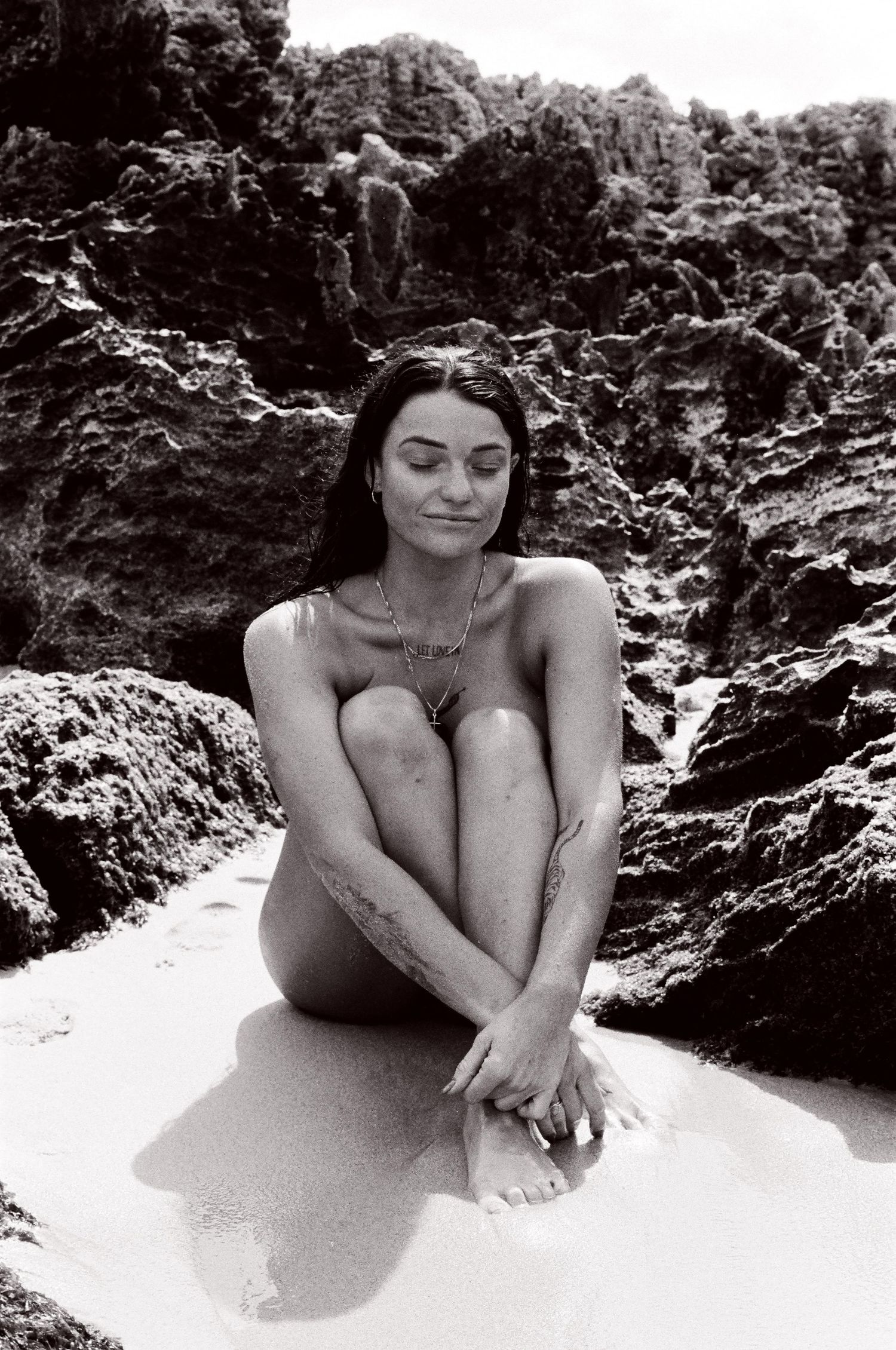 Grounded feminine portrait by the reef edge — slow and intentional session at Mettam’s Pool in Perth.